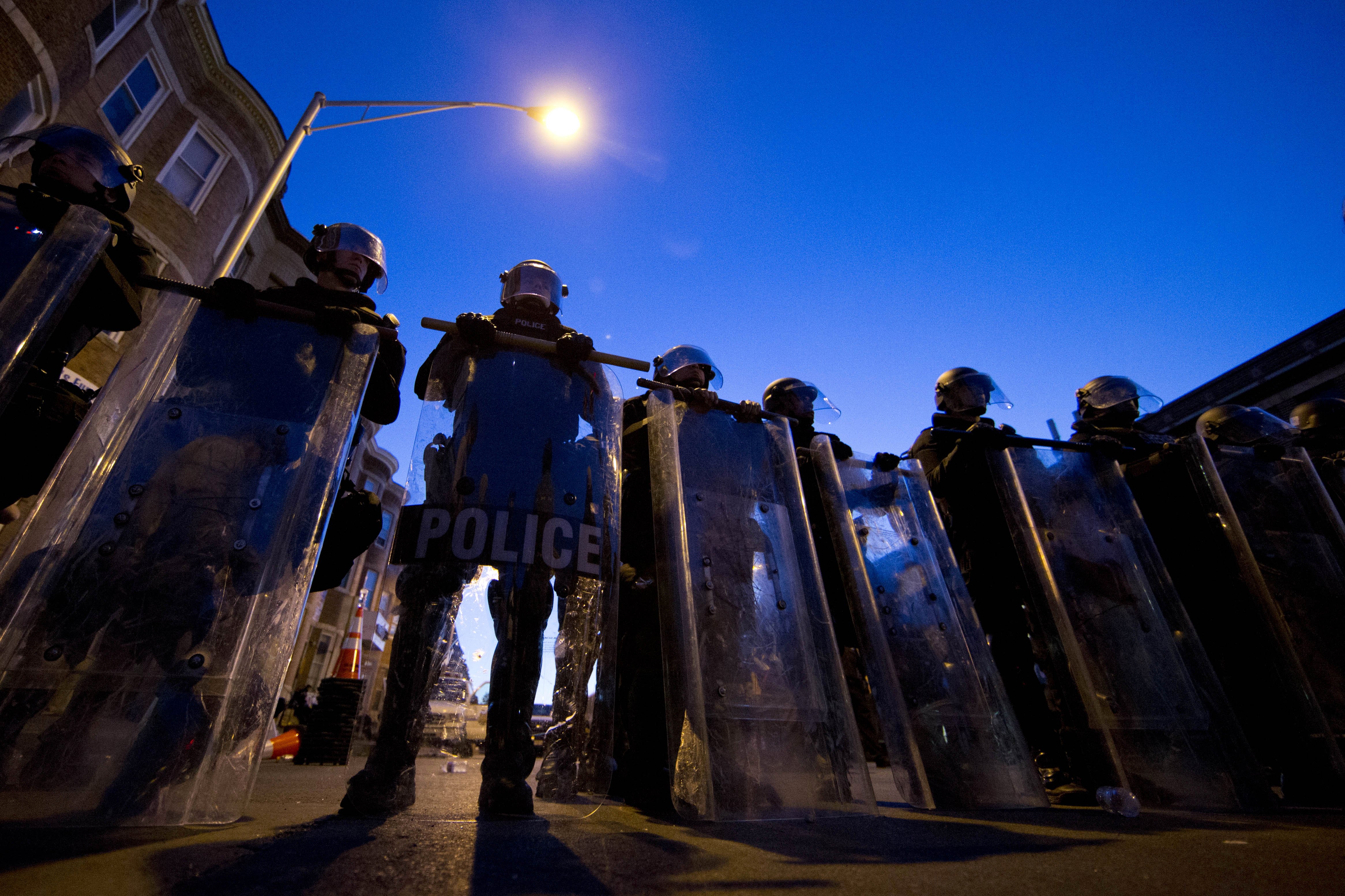 Police officers stand guard on April 28, 2015, in Baltimore.