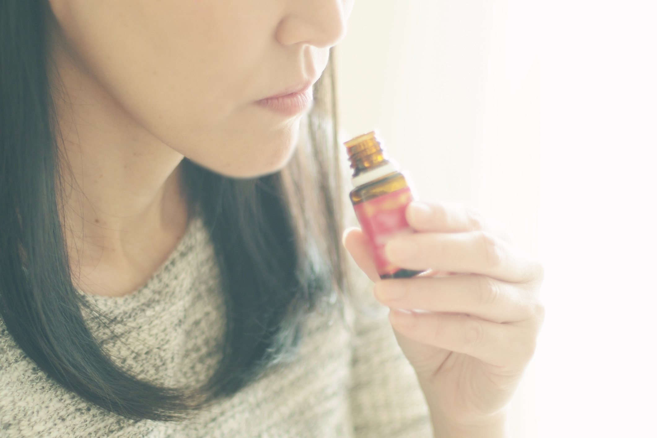 Woman smelling an essential oil