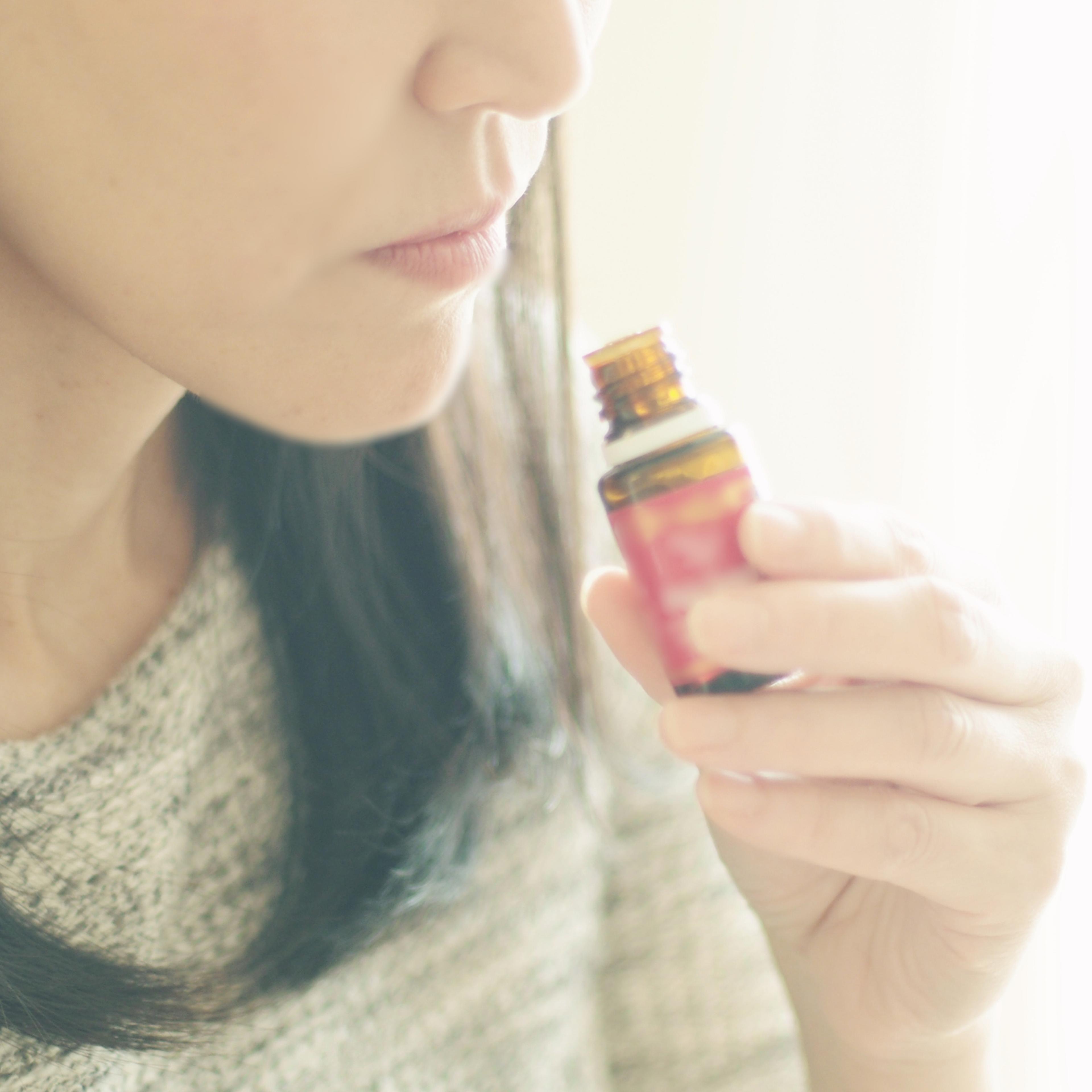Woman smelling an essential oil