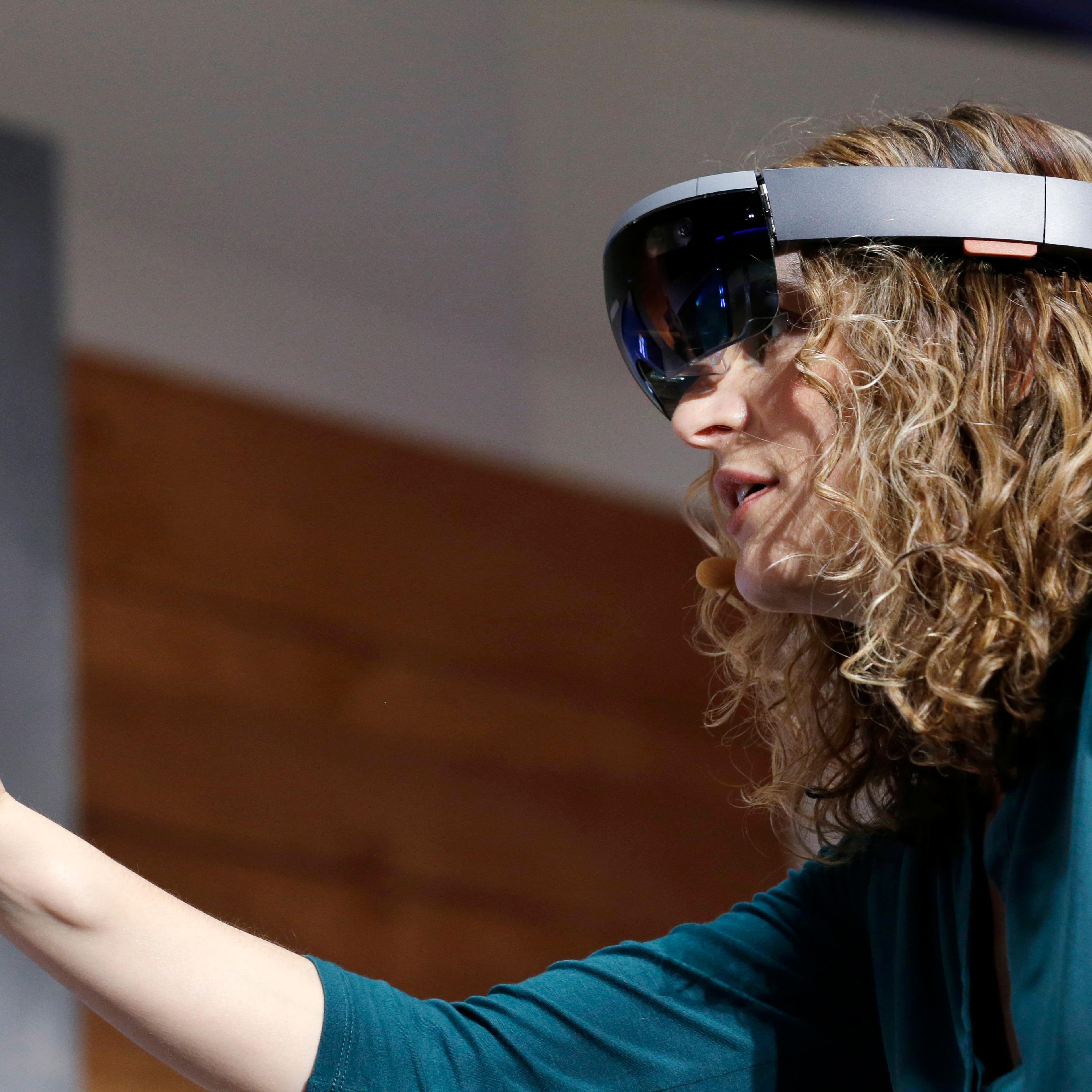 Microsoft's Lorraine Bardeen demonstrates HoloLens headset during an event at the company's headquarters in Redmond, Wash. on Jan. 21, 2015.