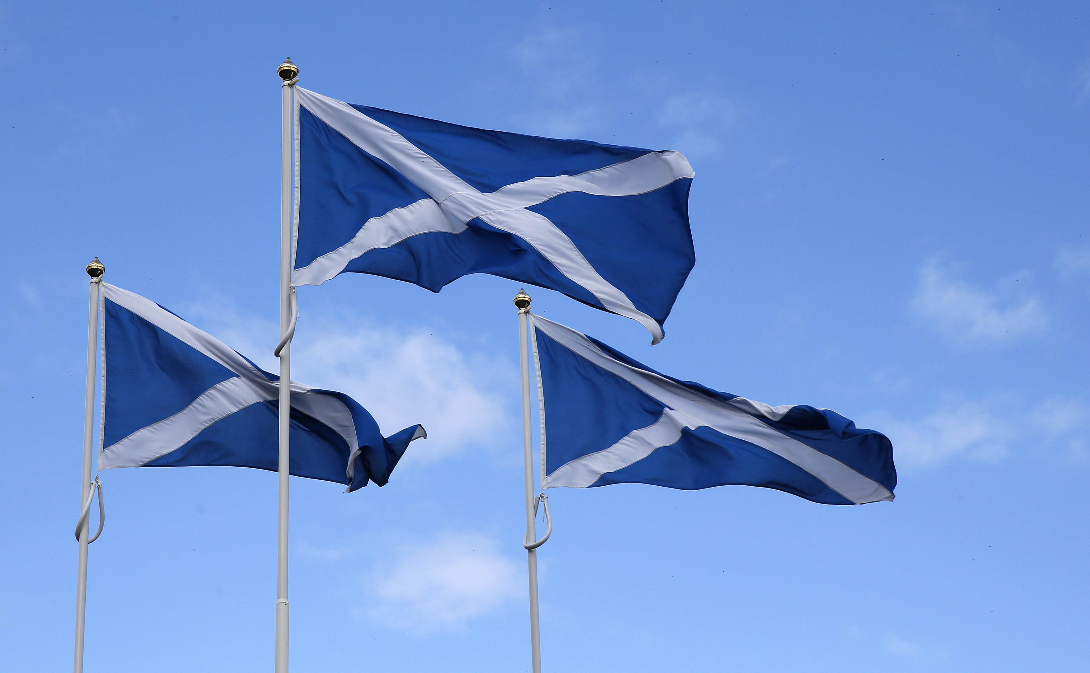 The Flag of Scotland, the Saltire, blows in the wind near Berwick-upon-Tweed on the border between England and Scotland