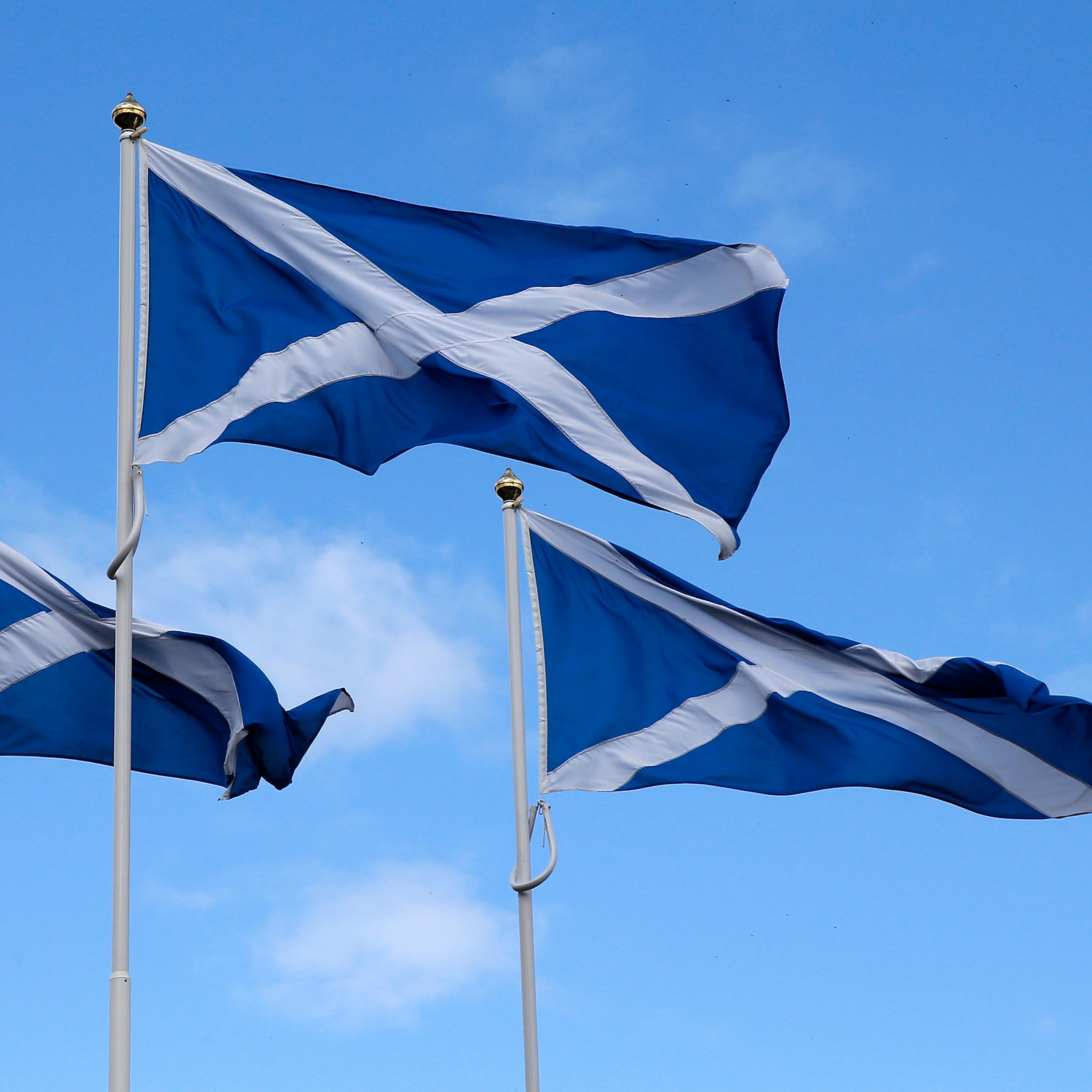 The Flag of Scotland, the Saltire, blows in the wind near Berwick-upon-Tweed on the border between England and Scotland