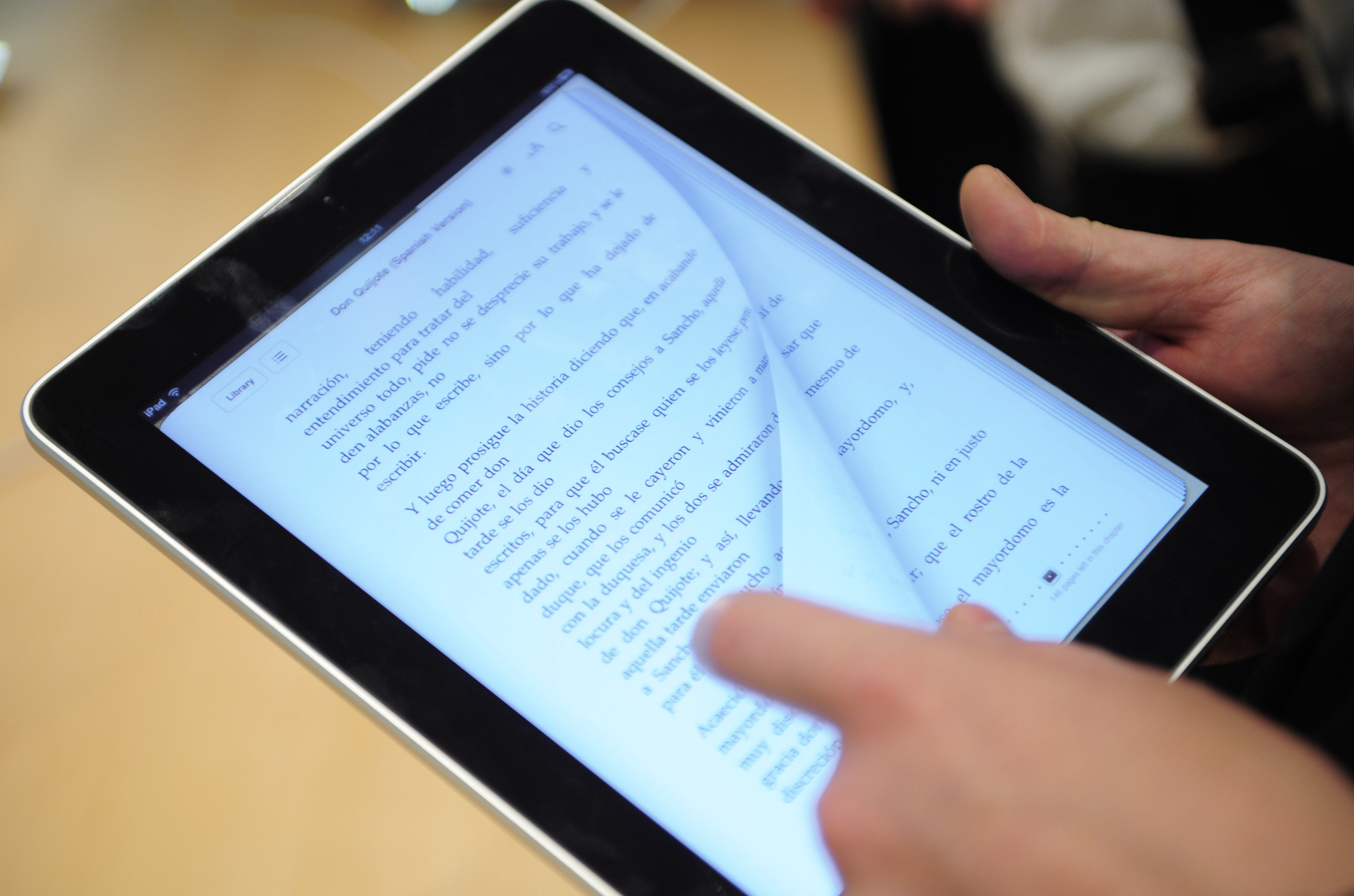 A customer is reading on an iPad at an Apple store Barcelona on May 28, 2010.