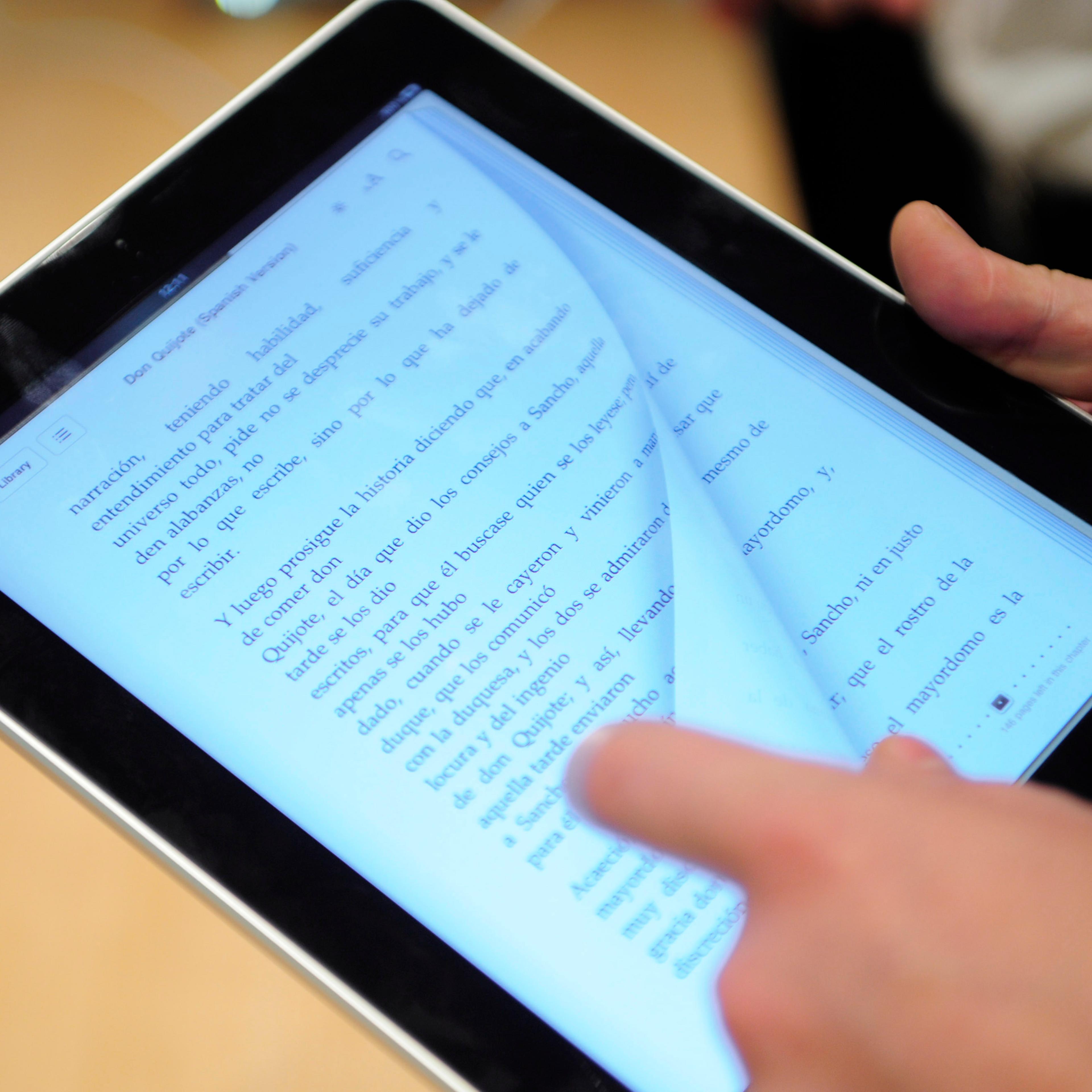 A customer is reading on an iPad at an Apple store Barcelona on May 28, 2010.