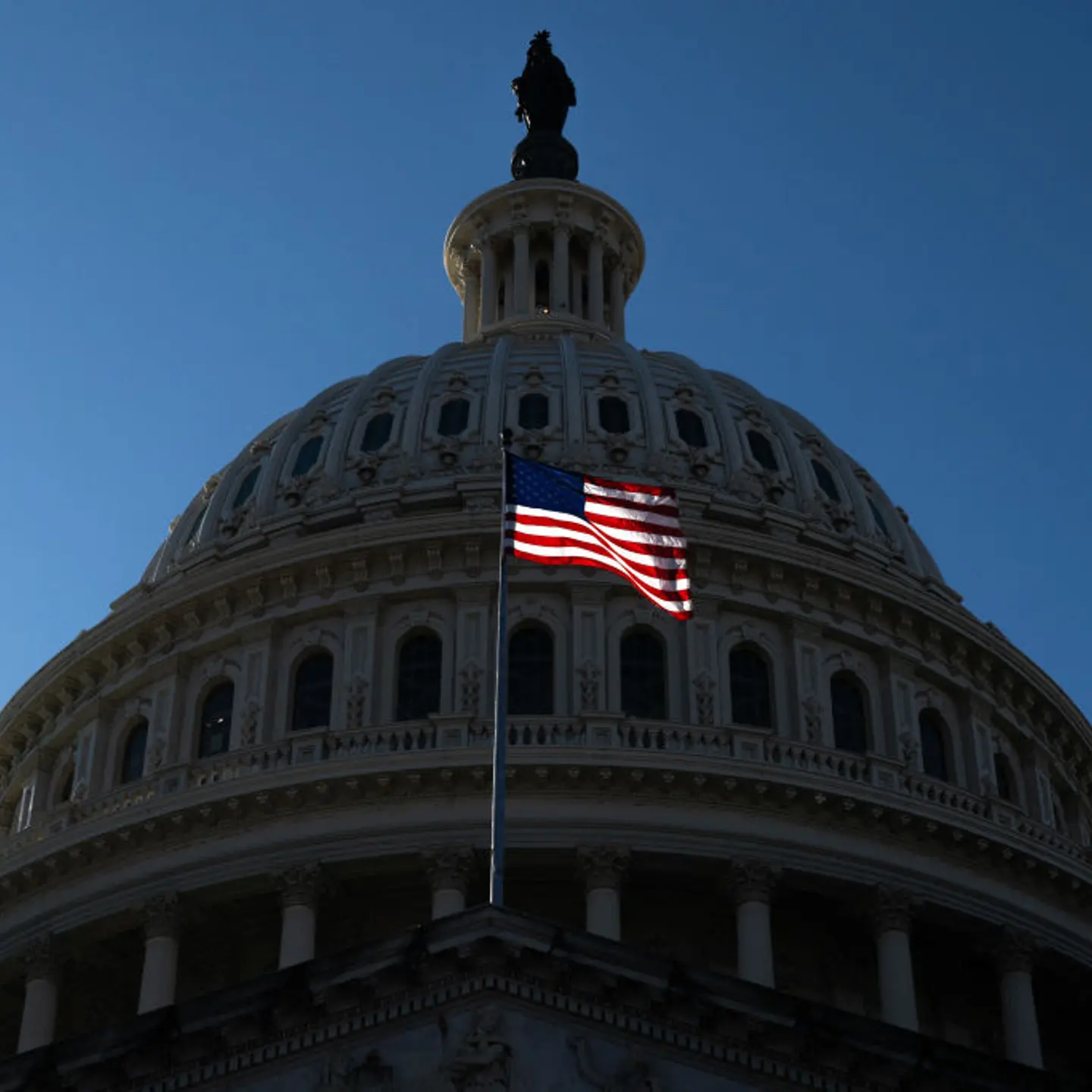 A U.S. flag flies near the dome of the Capitol