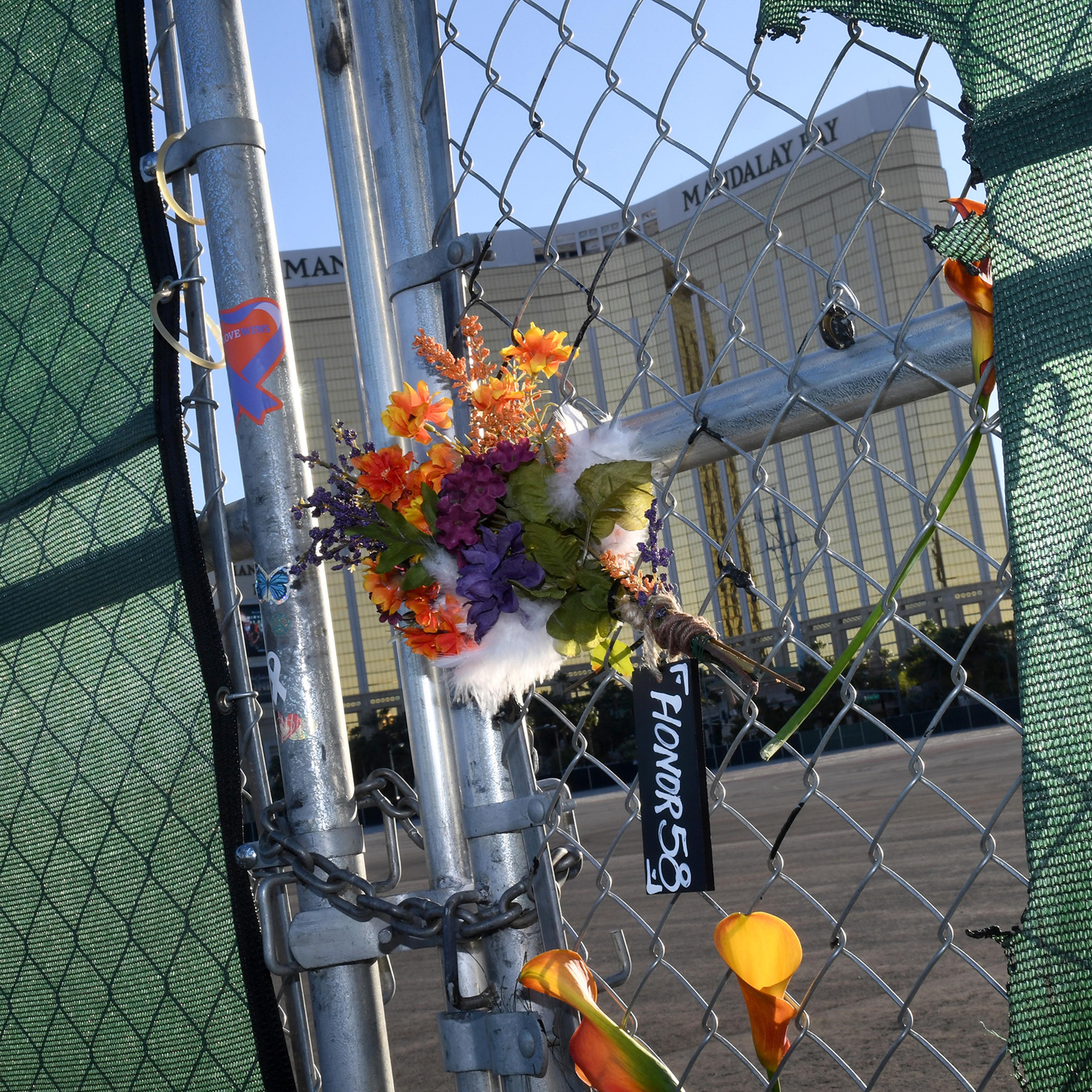 Flowers and a sign hang on a fence across from Mandalay Bay Resort and Casino as a tribute to those killed almost two years ago in a massacre at the site on Sept. 30, 2019 in Las Vegas