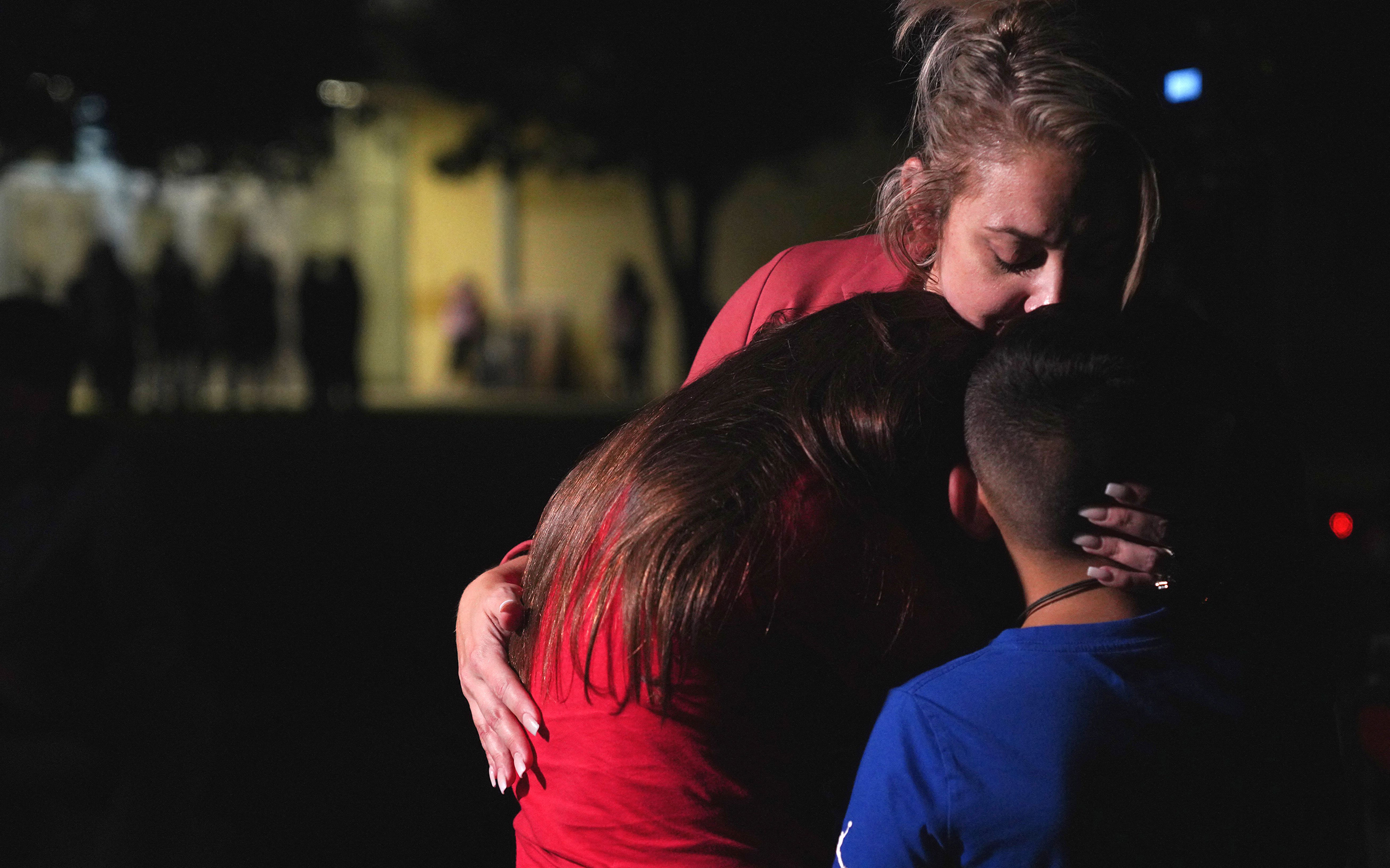 A family hugs outside the Willie de Leon Civic Center where grief counseling will be offered in Uvalde, Texas, on May 24, 2022. 