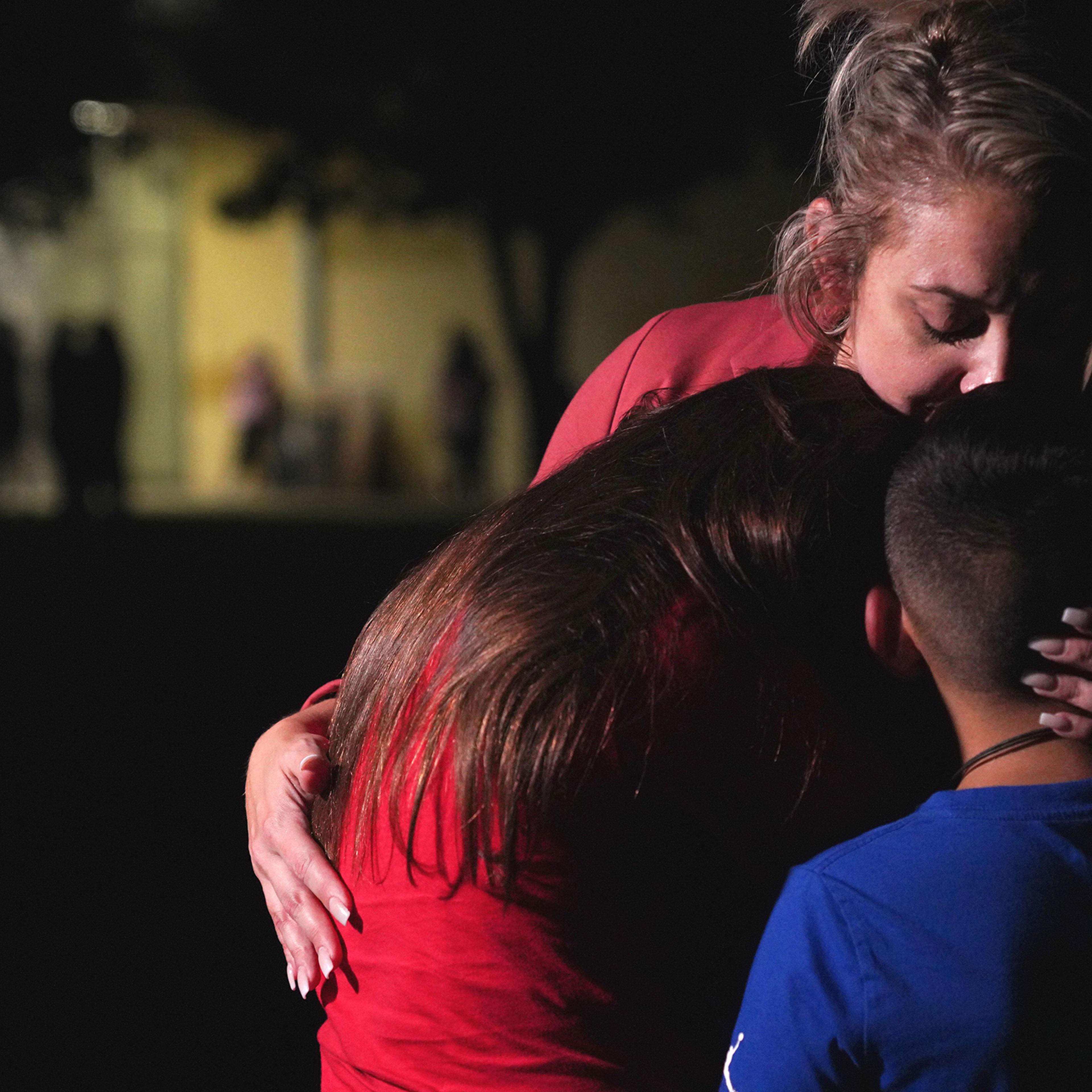 A family hugs outside the Willie de Leon Civic Center where grief counseling will be offered in Uvalde, Texas, on May 24, 2022.