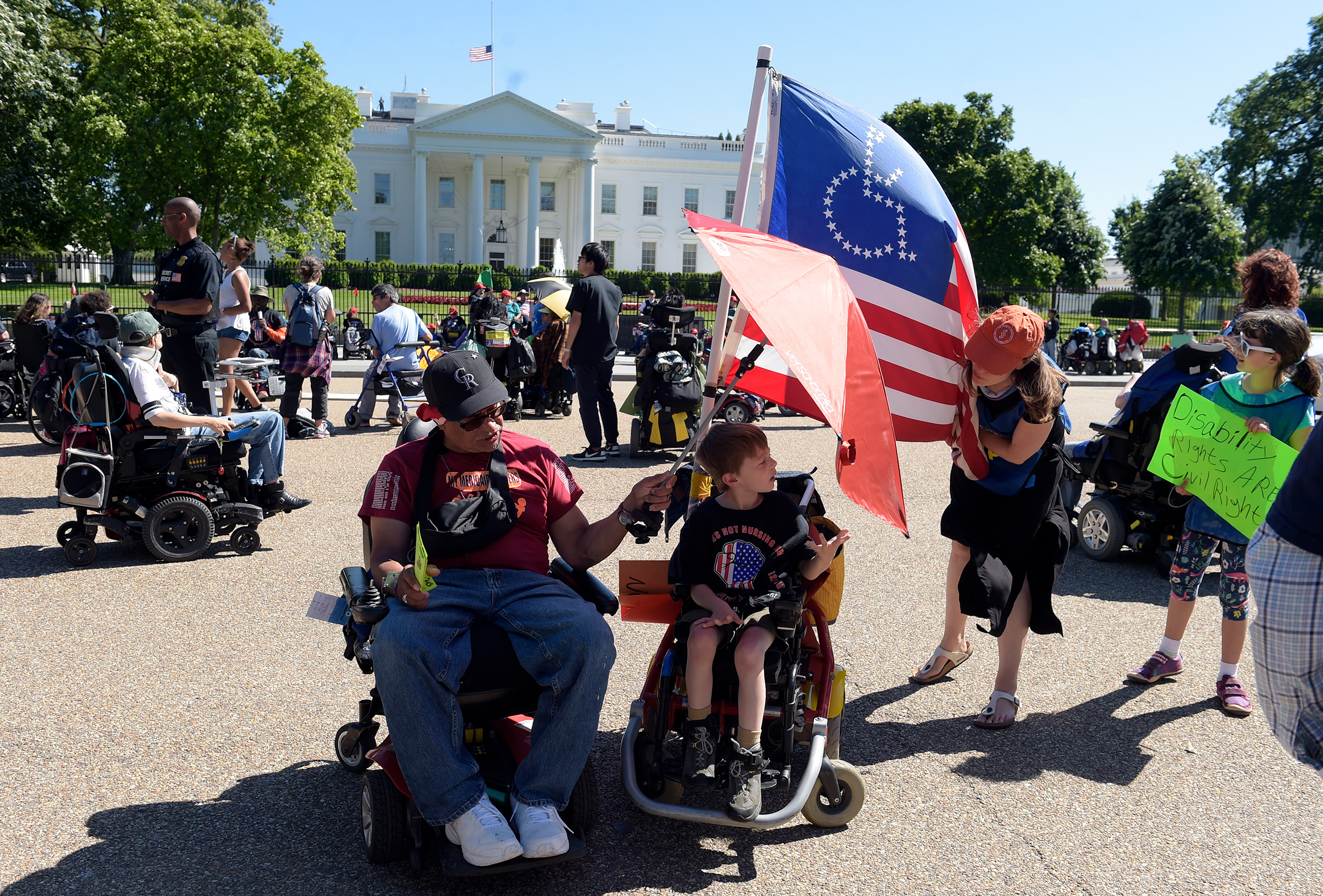Protesters supporting people with disabilities gather outside the White House in Washington, May 15, 2017