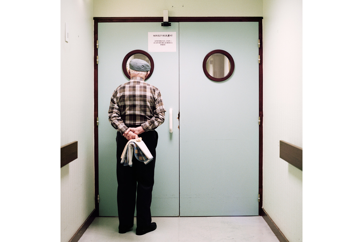 A resident stands in front of the ward’s locked exit door. Passages are blocked and doors are locked to prevent residents from wandering off. Photographer Maja Daniels spent three years, beginning in 2008, documenting the ward and its residents