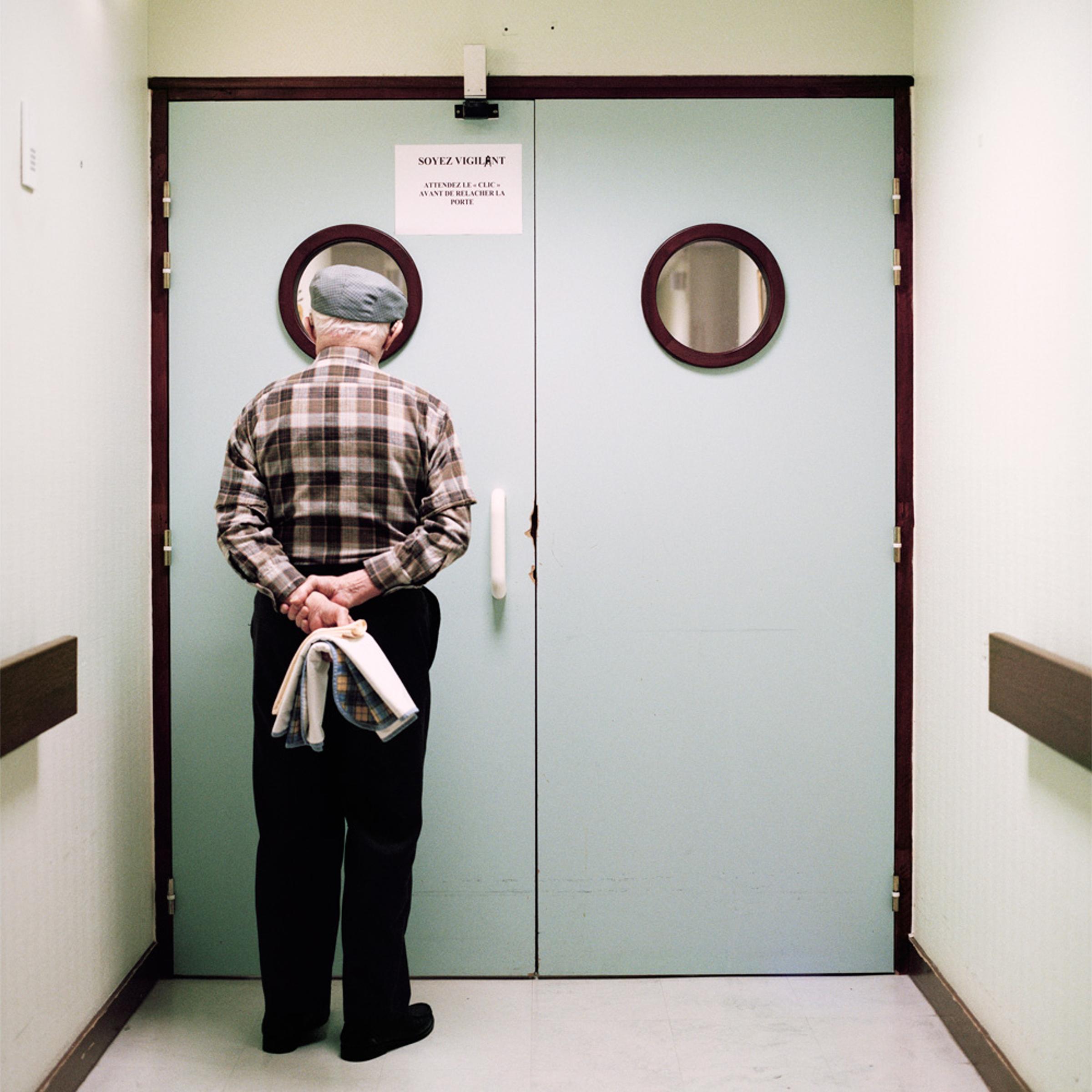 A resident stands in front of the ward’s locked exit door. Passages are blocked and doors are locked to prevent residents from wandering off. Photographer Maja Daniels spent three years, beginning in 2008, documenting the ward and its residents