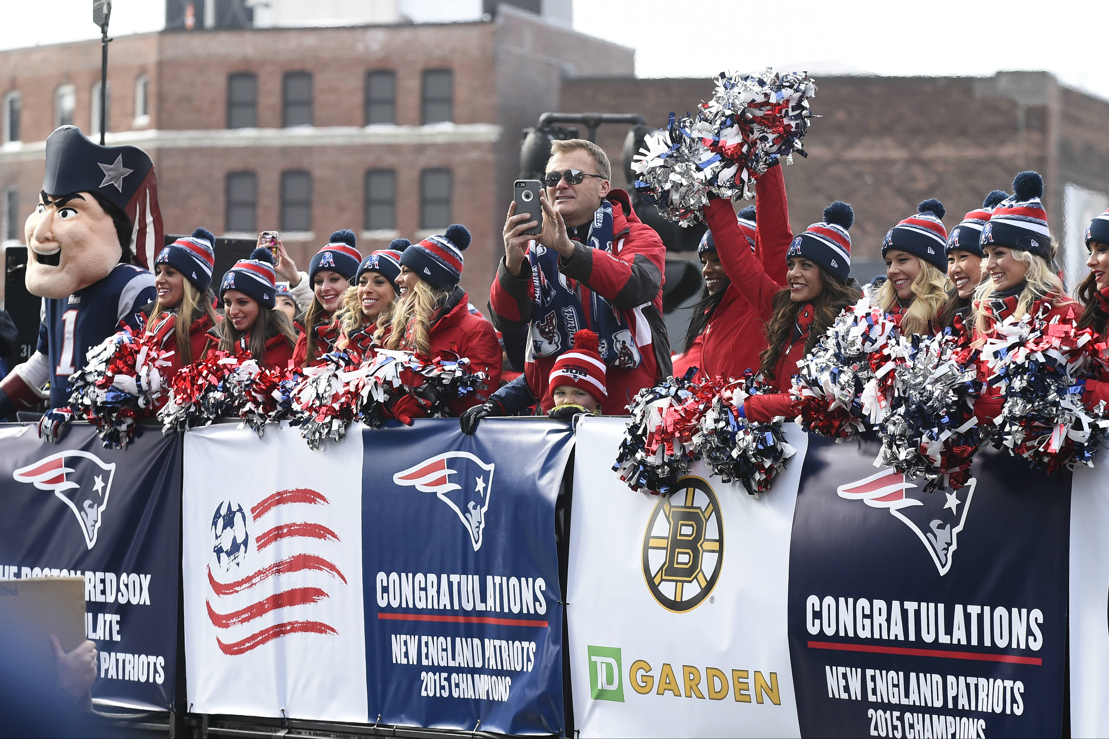 Former New England Patriot Scott Zolack rides with the cheerleaders during a parade held in Boston to celebrate the team's victory over the Seattle Seahawks in Super Bowl XLIX on February 4, 2015.