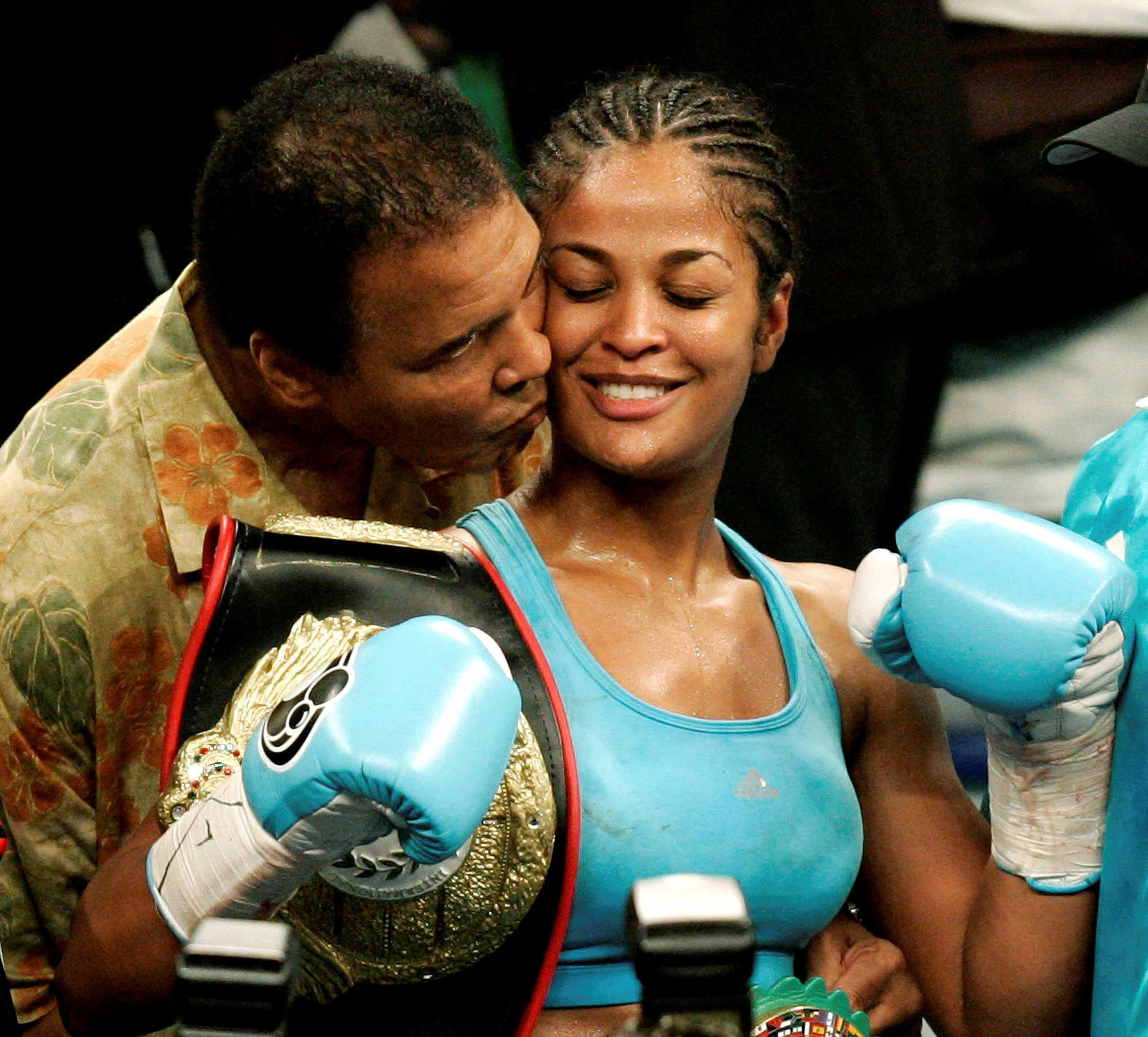 Laila Ali is kissed by her father, boxing great Muhammad Ali, at the MCI Center in Washington D.C., June 11, 2005.