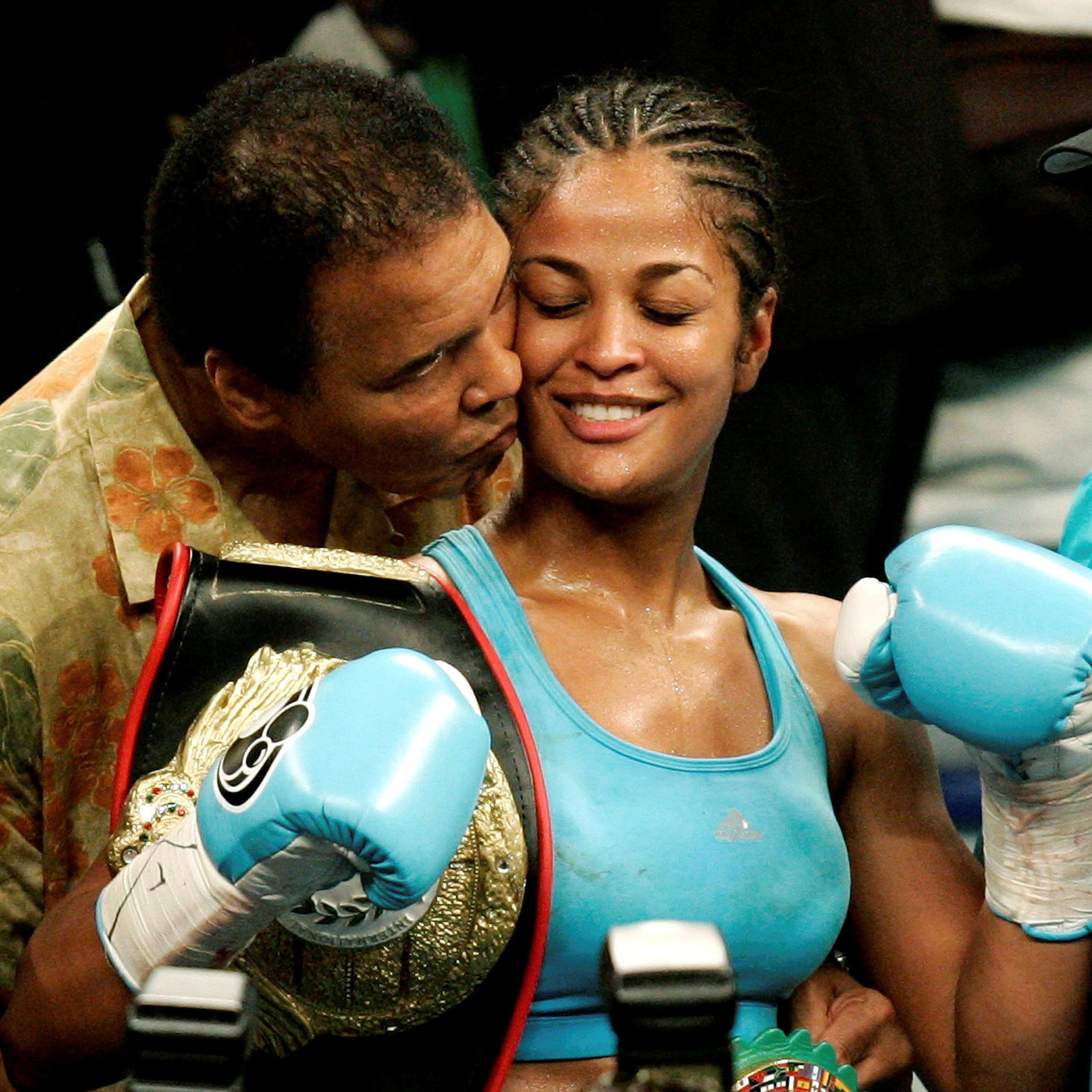 Laila Ali is kissed by her father, boxing great Muhammad Ali, at the MCI Center in Washington D.C., June 11, 2005.