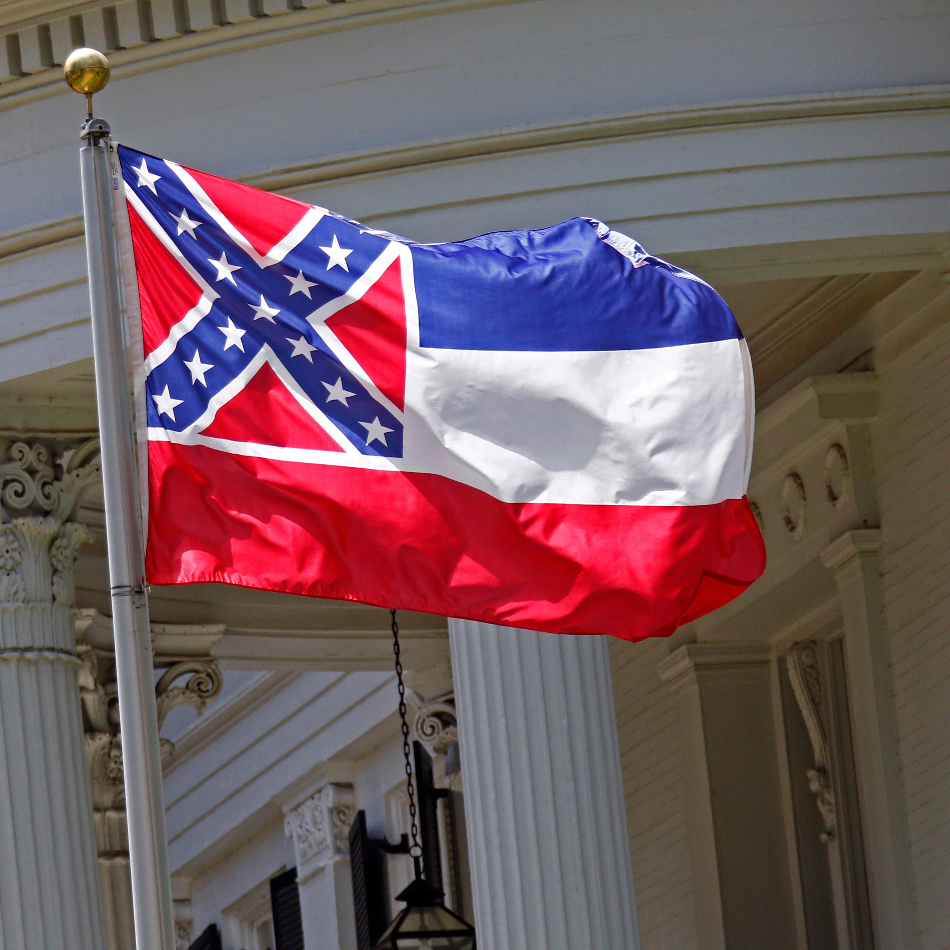 The state flag of Mississippi is unfurled against the front of the Governor's Mansion in Jackson, Miss. on June 23, 2015.