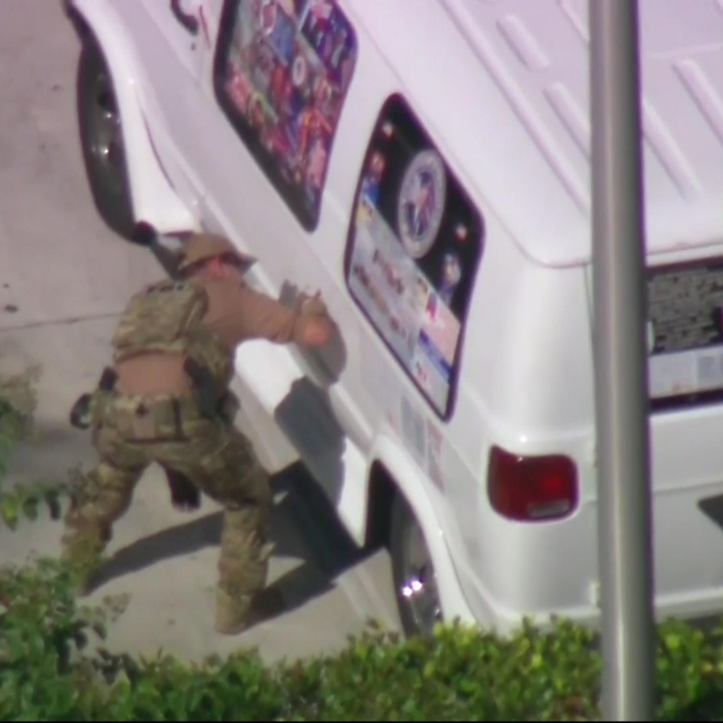 Authorities are seen in Plantation, Florida taking a man into custody in connection to the mailed package bombs.