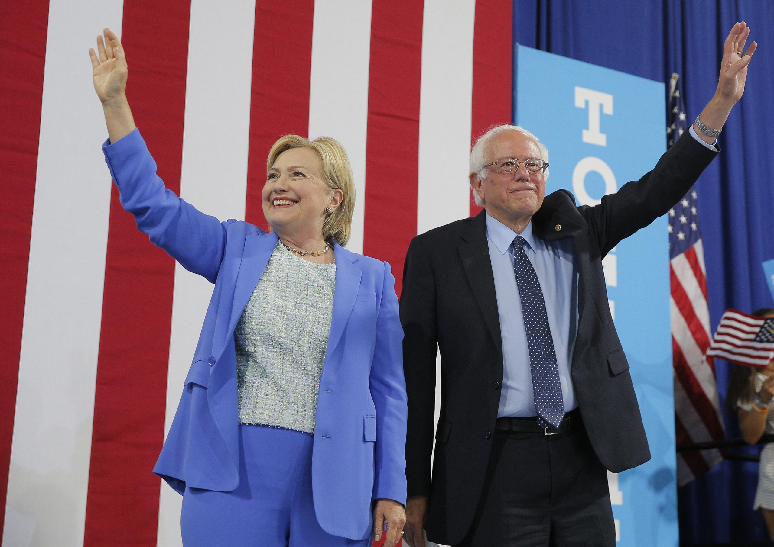 Democratic Presidential candidate Hillary Clinton and Sen. Bernie Sanders stand together during a campaign rally where Sanders endorsed Clinton in Portsmouth, N.H. on July 12, 2016.