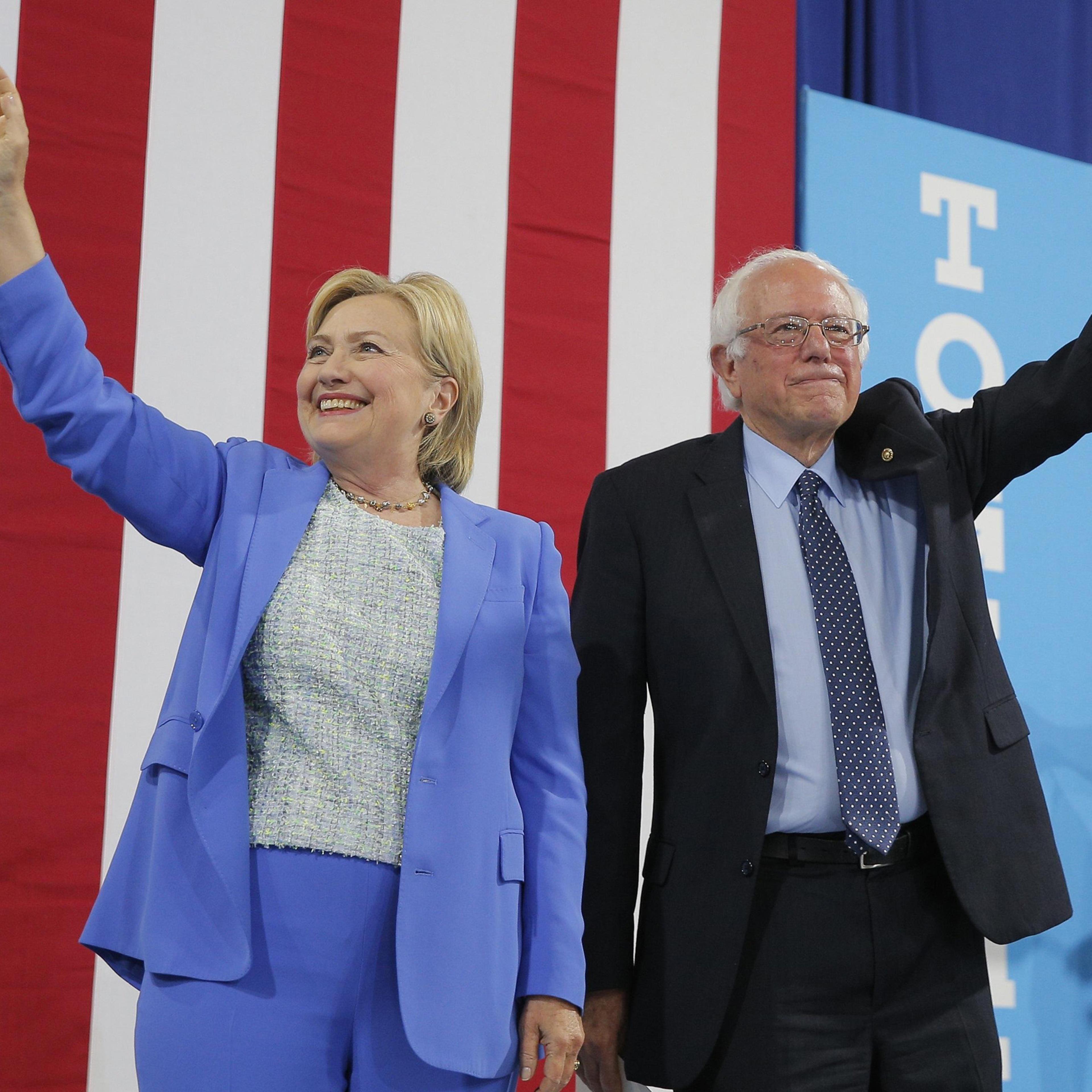 Democratic Presidential candidate Hillary Clinton and Sen. Bernie Sanders stand together during a campaign rally where Sanders endorsed Clinton in Portsmouth, N.H. on July 12, 2016.
