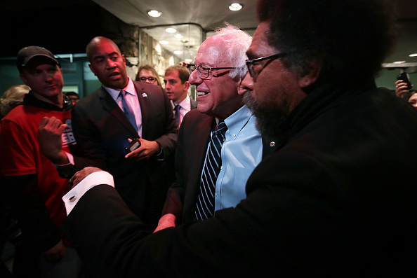Philosopher Cornel West (R) greets Democratic presidential candidate Sen. Bernie Sanders (I-VT) at a watch party for the second Democratic presidential debate November 14, 2015 in Des Moines, Iowa.