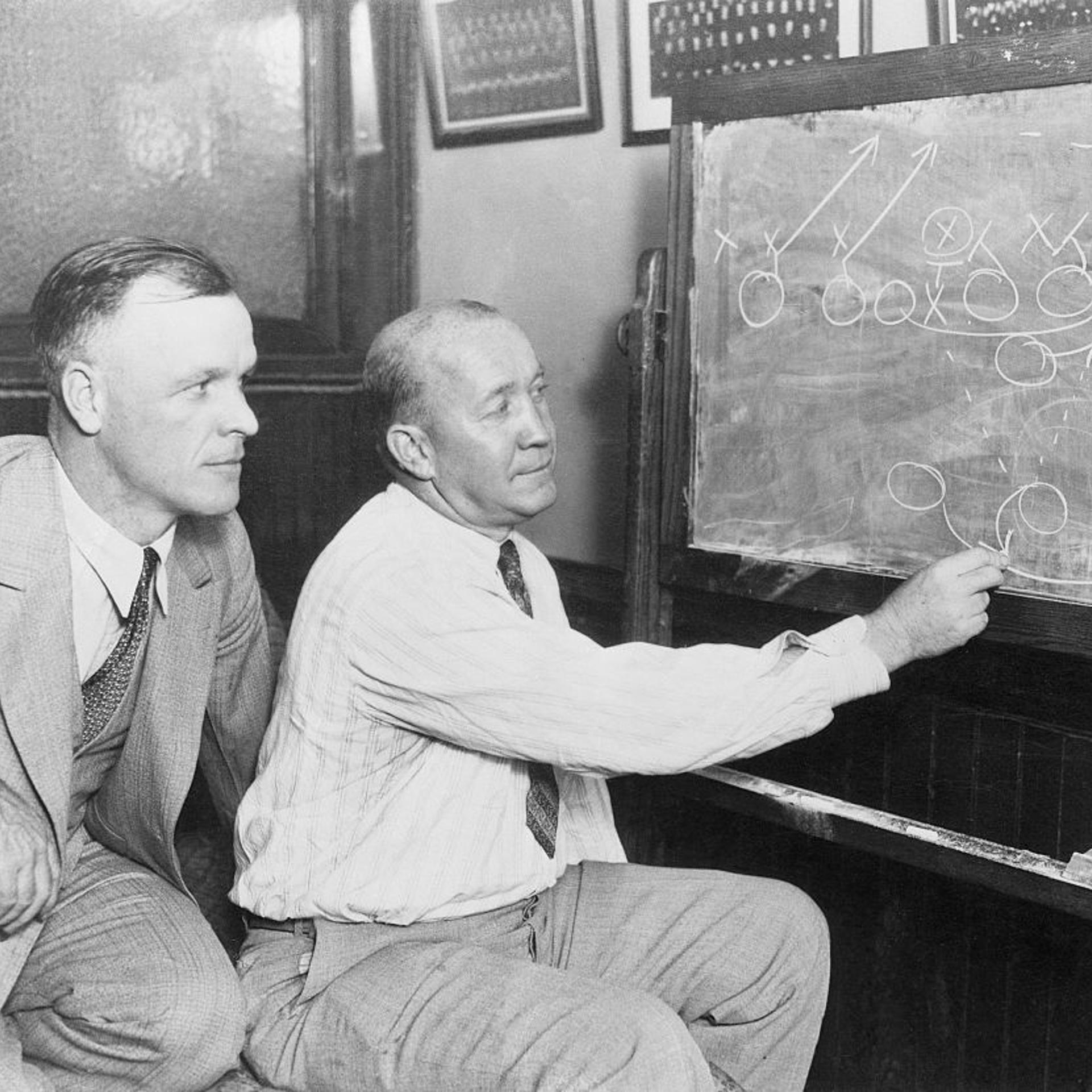 Knute Rockne Going over Plays on Blackboard