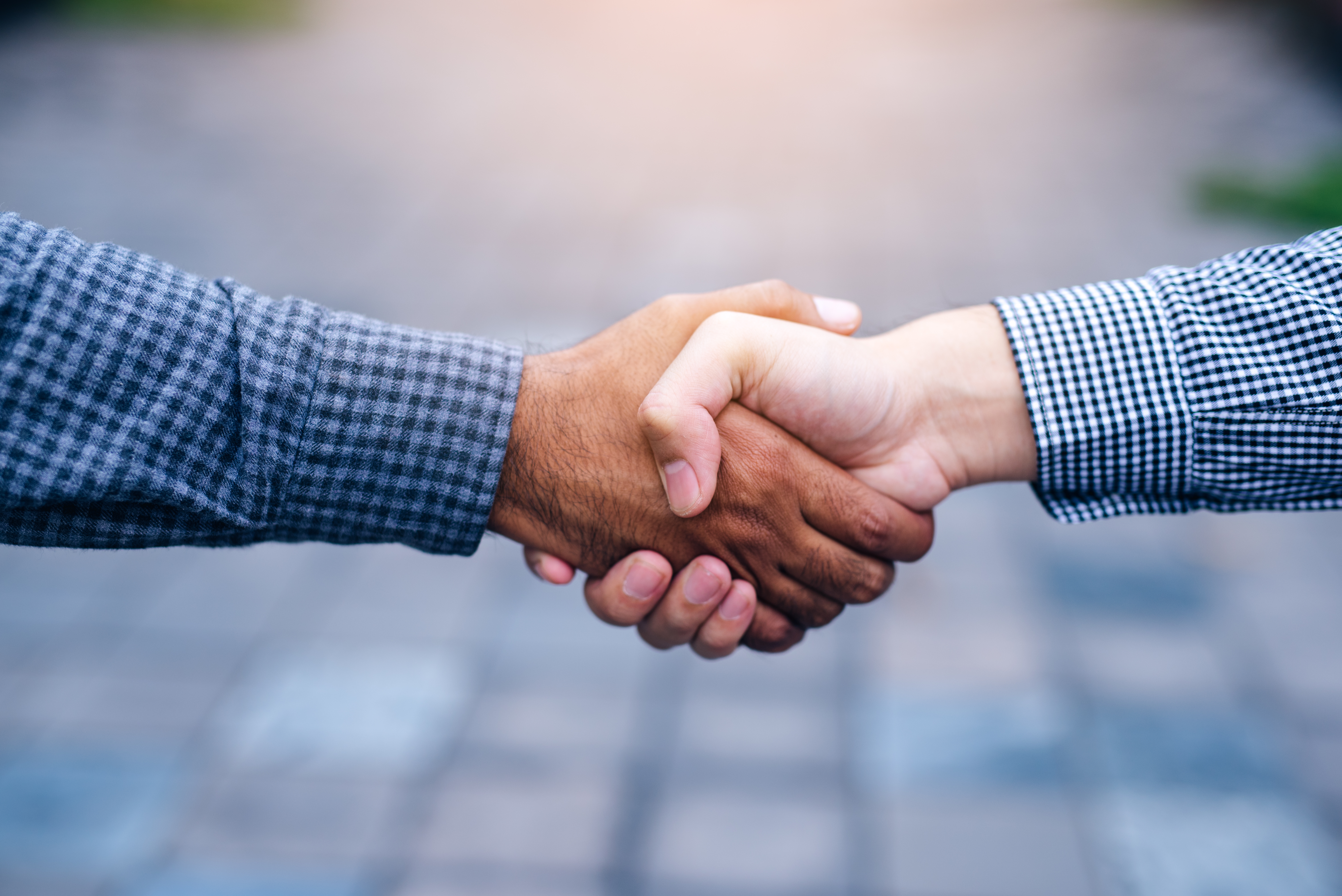Scene of businessman handshake in outdoors