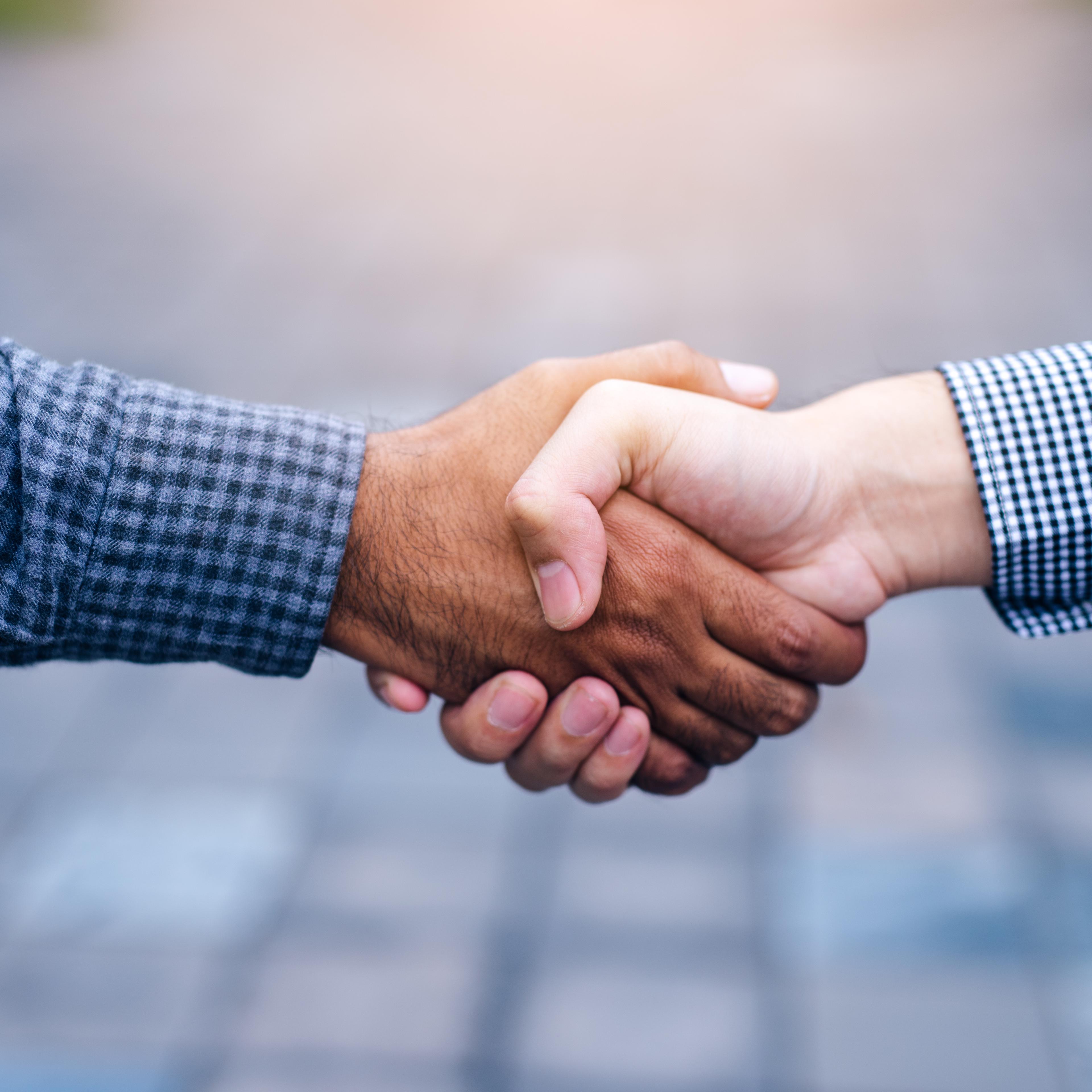 Scene of businessman handshake in outdoors