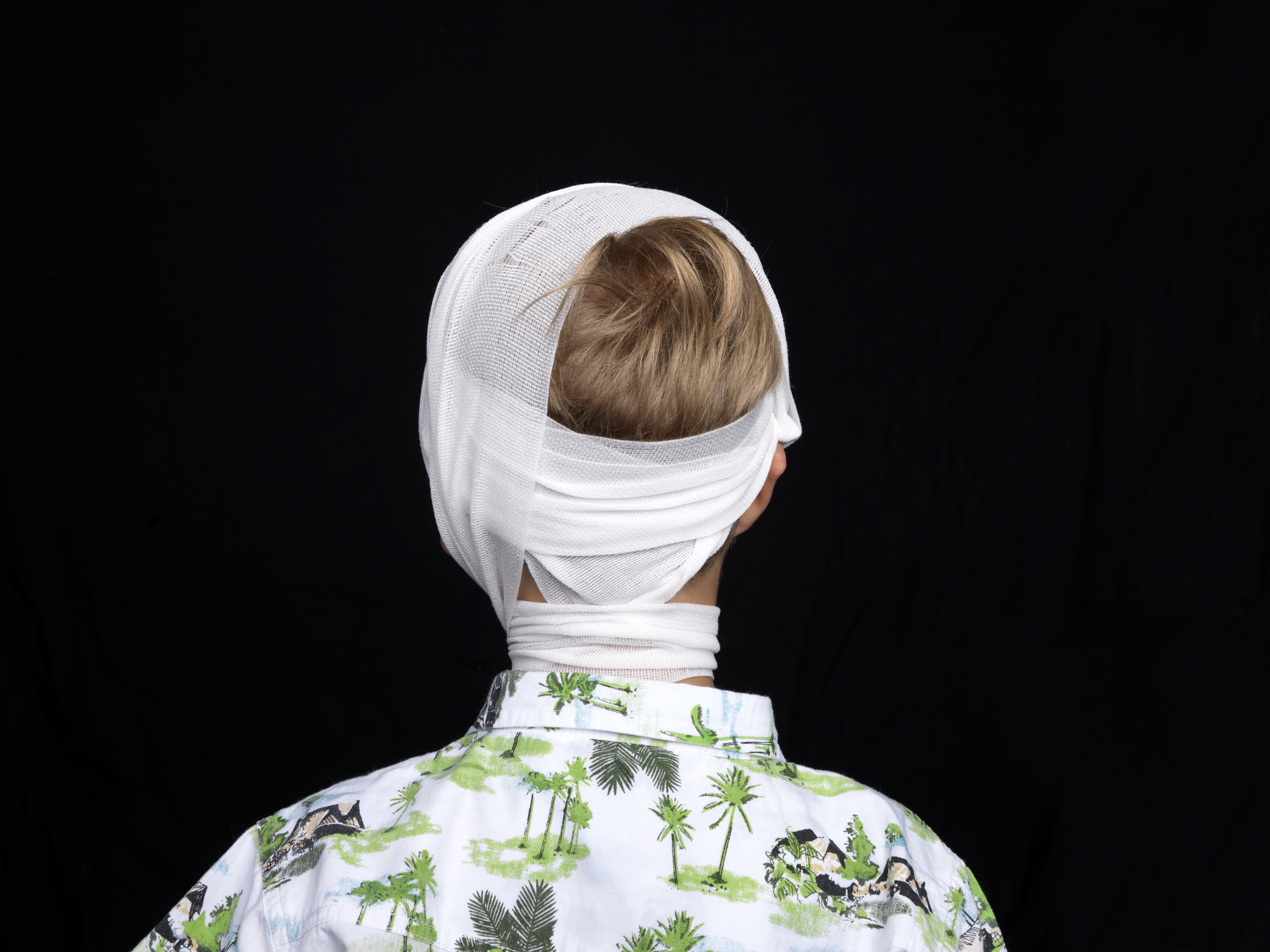 Young boy in head bandage