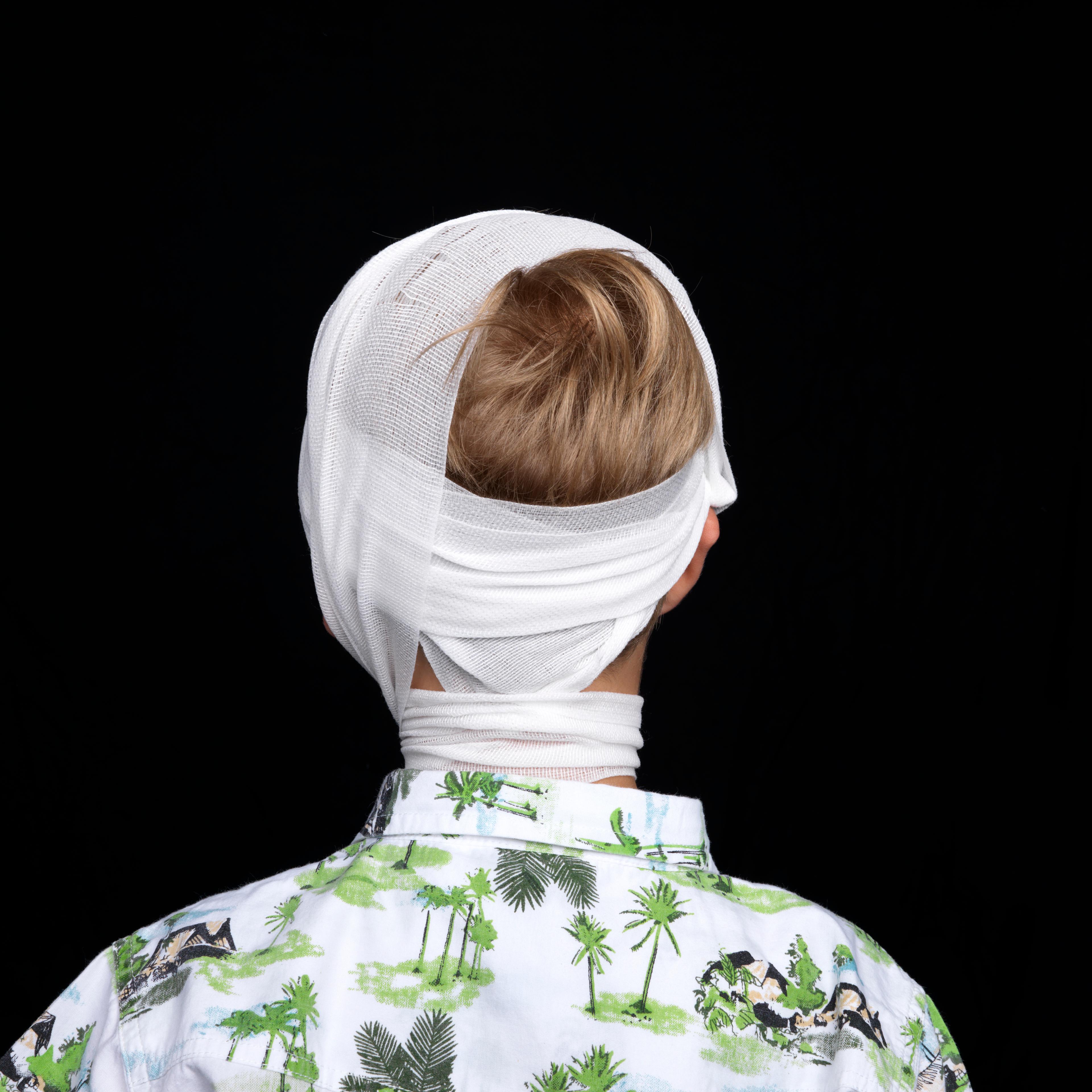 Young boy in head bandage