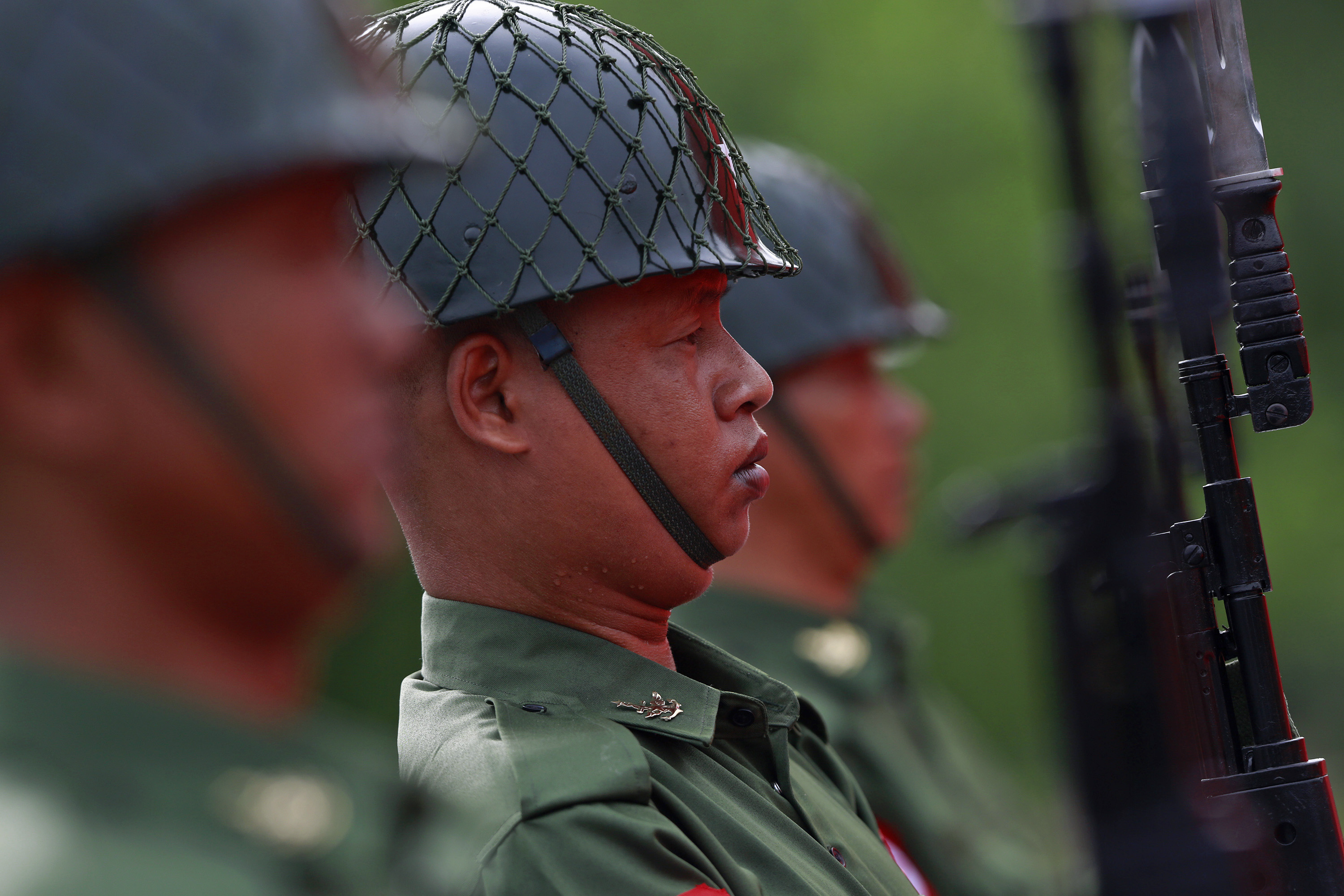 Guards of honour salute during an event marking the anniversary of Martyrs' Day at the Martyrs Mausoleum in Yangon
