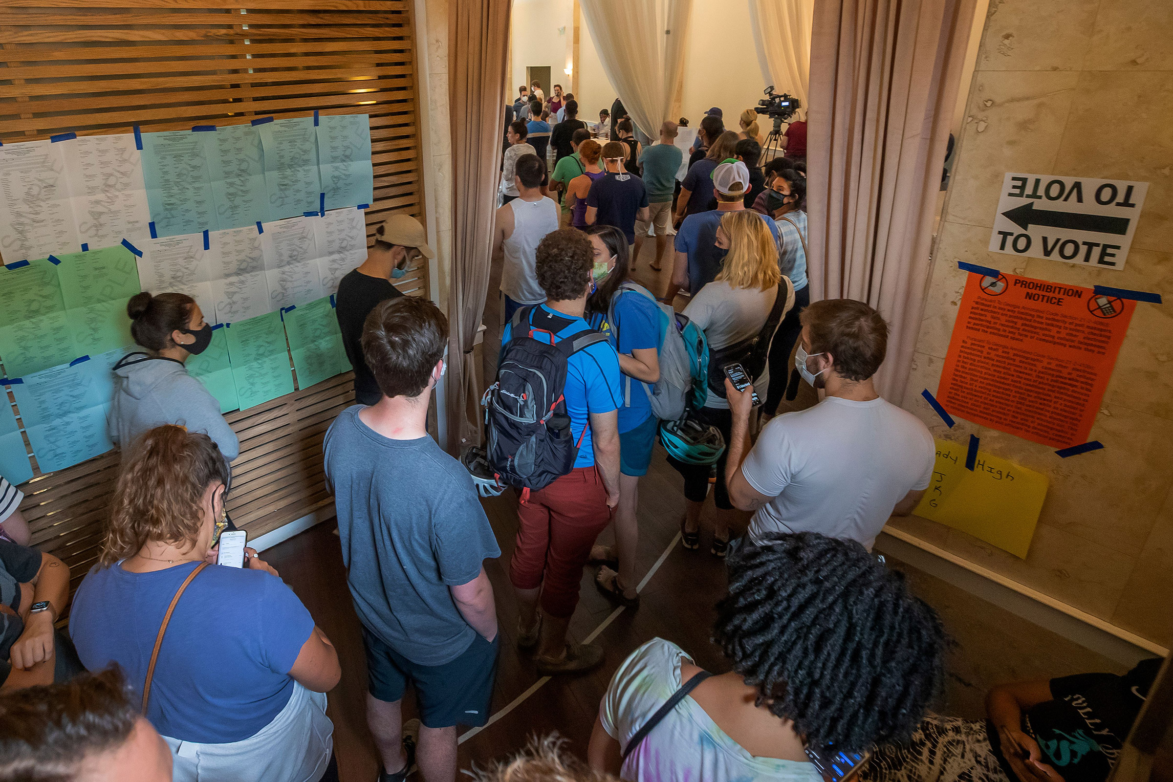 Voters wait in line to vote in Georgia's primary at Fulton County's Park Tavern precinct in Atlanta, June 9, 2020.