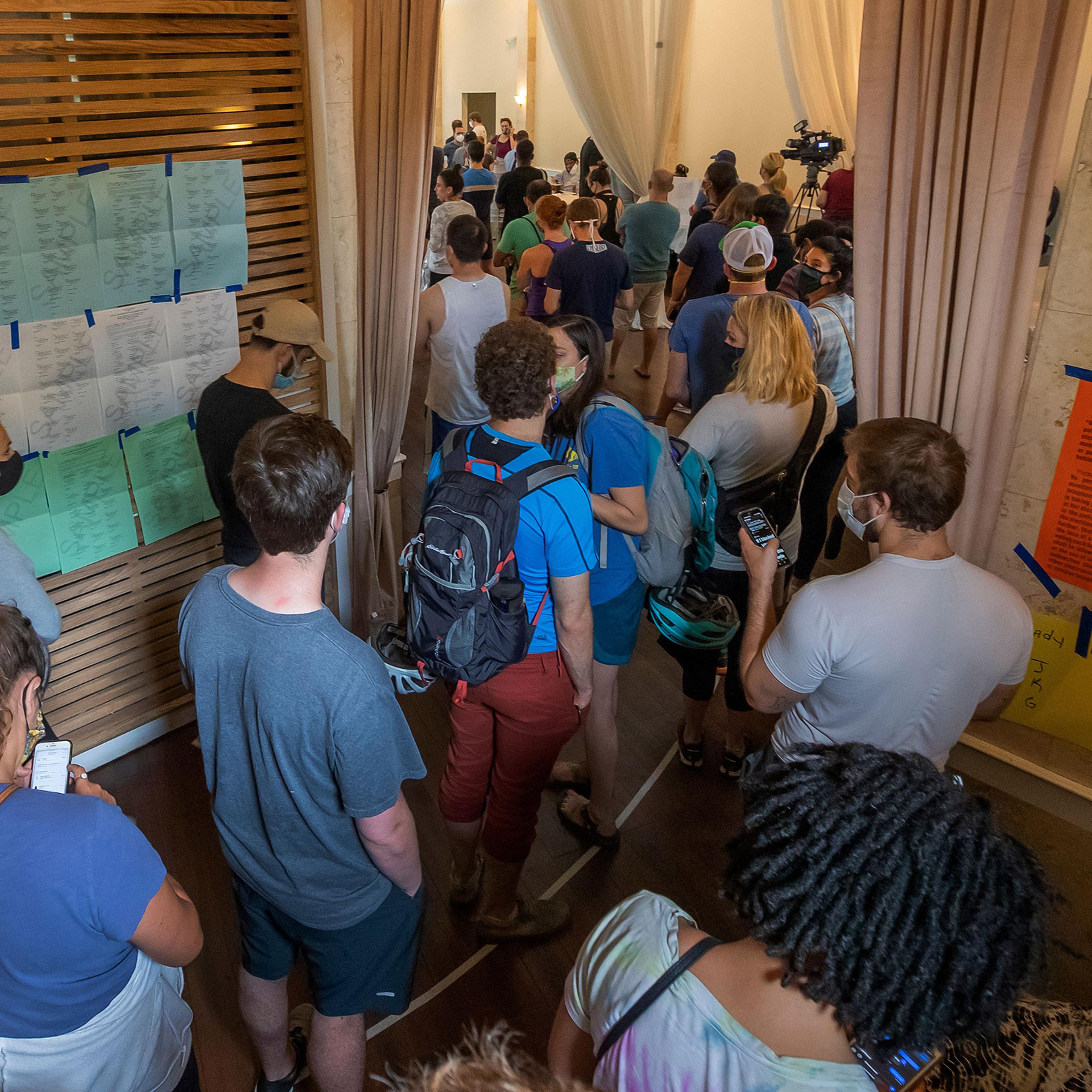 Voters wait in line to vote in Georgia's primary at Fulton County's Park Tavern precinct in Atlanta, June 9, 2020.