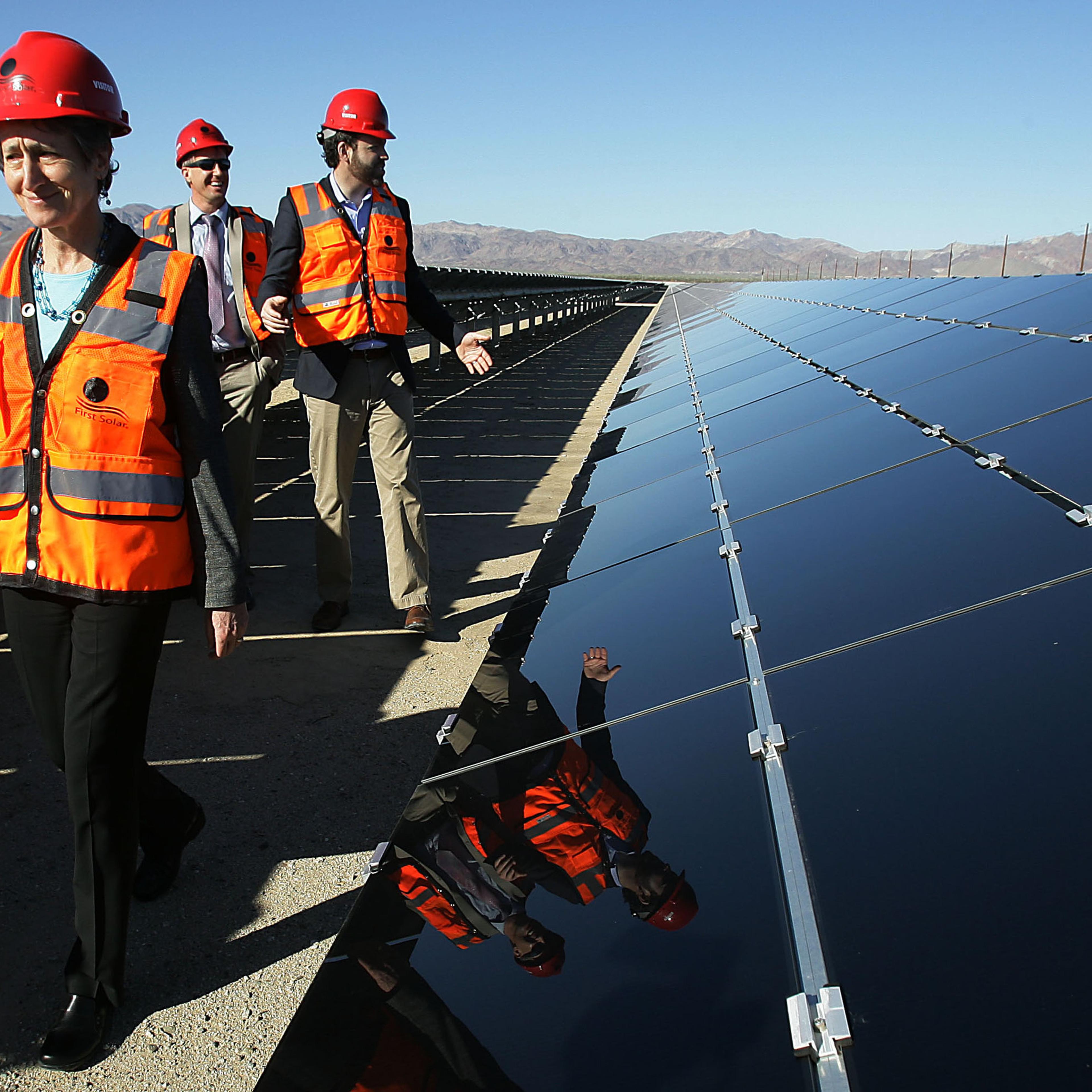 U.S. Secretary of Interior Sally Jewell, left, tours the more than six square miles of the plant during the power-on ceremony at Desert Sunlight Solar Farm in Desert Center, Calif., Feb. 9, 2015.