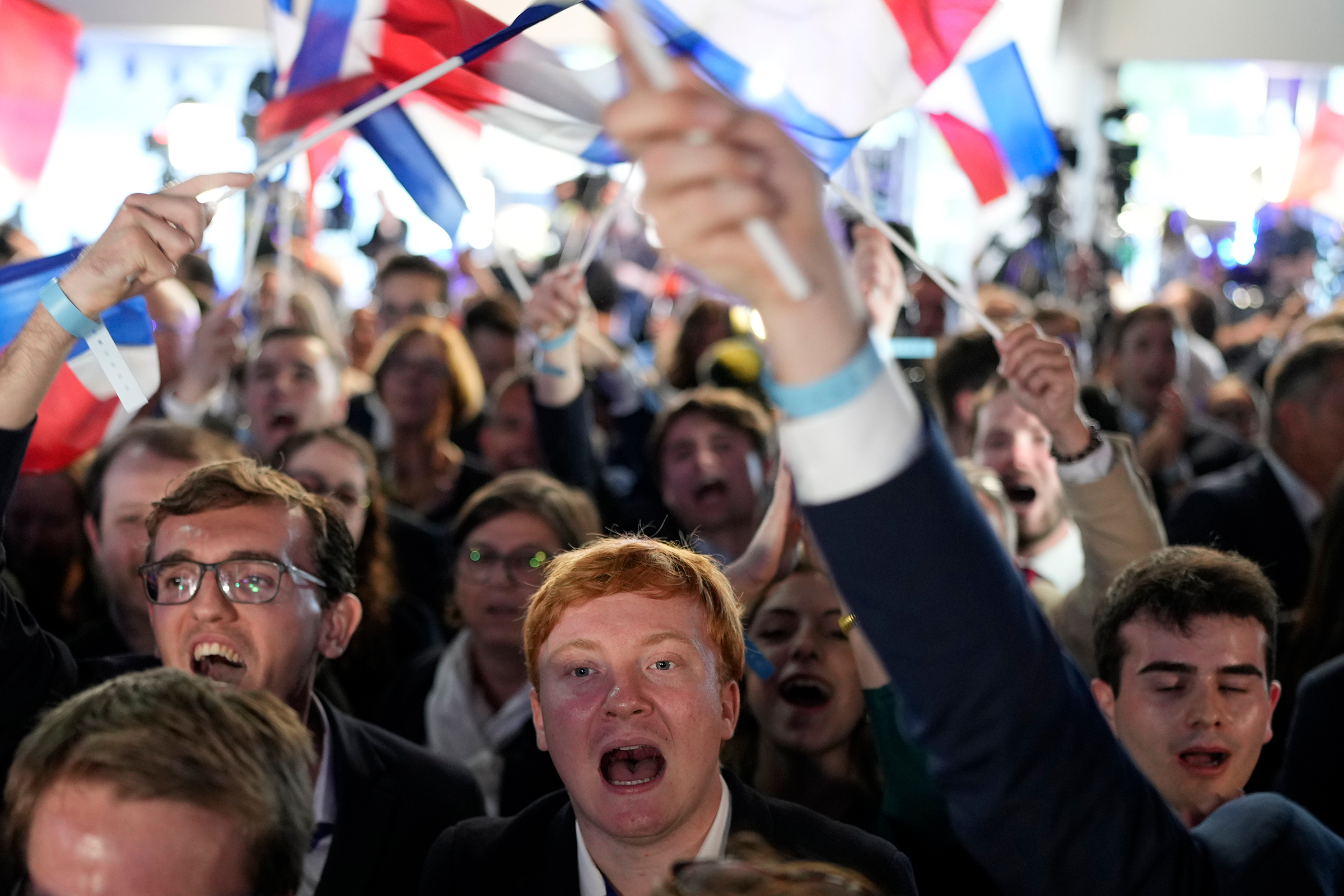 Supporters of French far-right National Rally react at the party election night headquarters on June 9 in Paris.