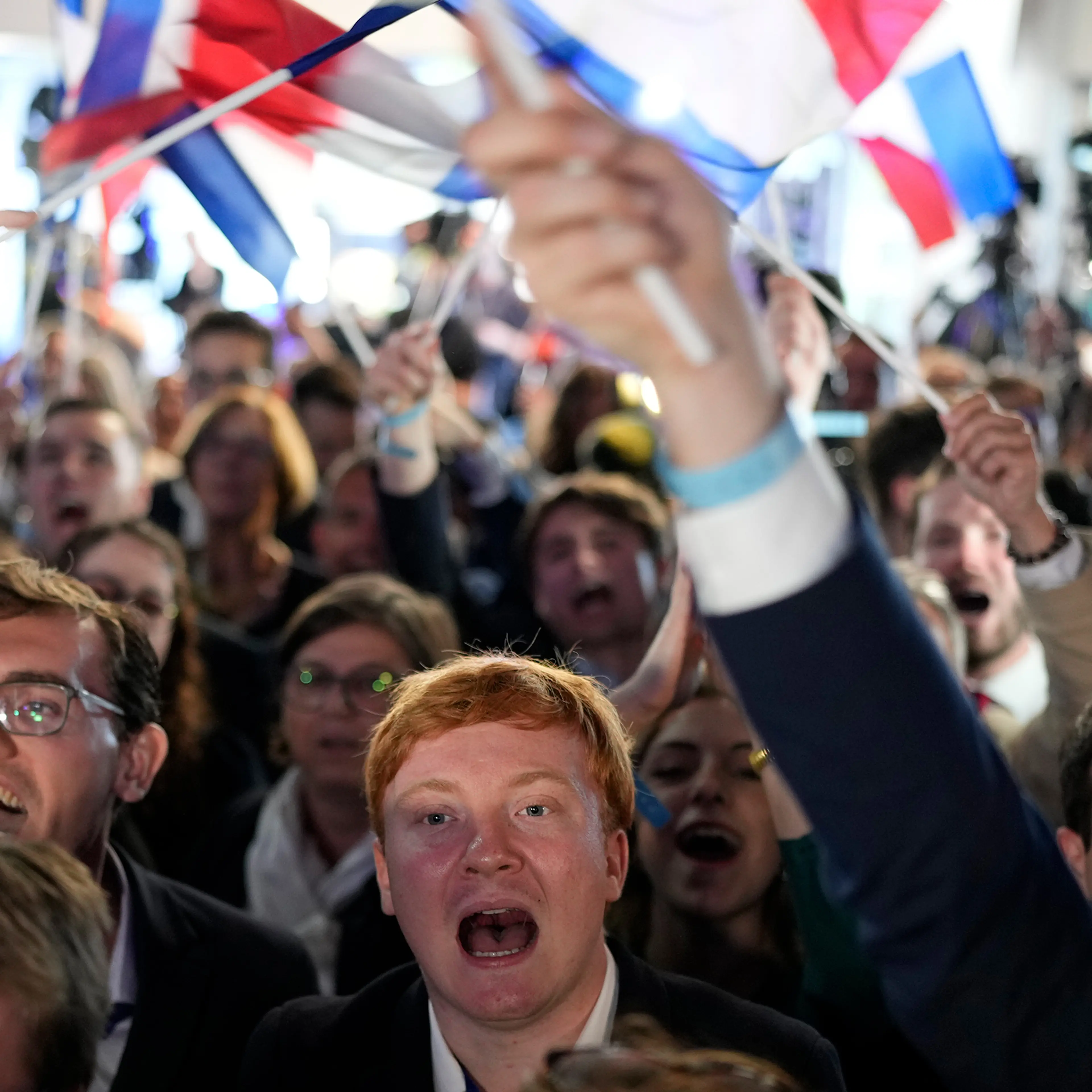 Supporters of French far-right National Rally react at the party election night headquarters on June 9 in Paris.