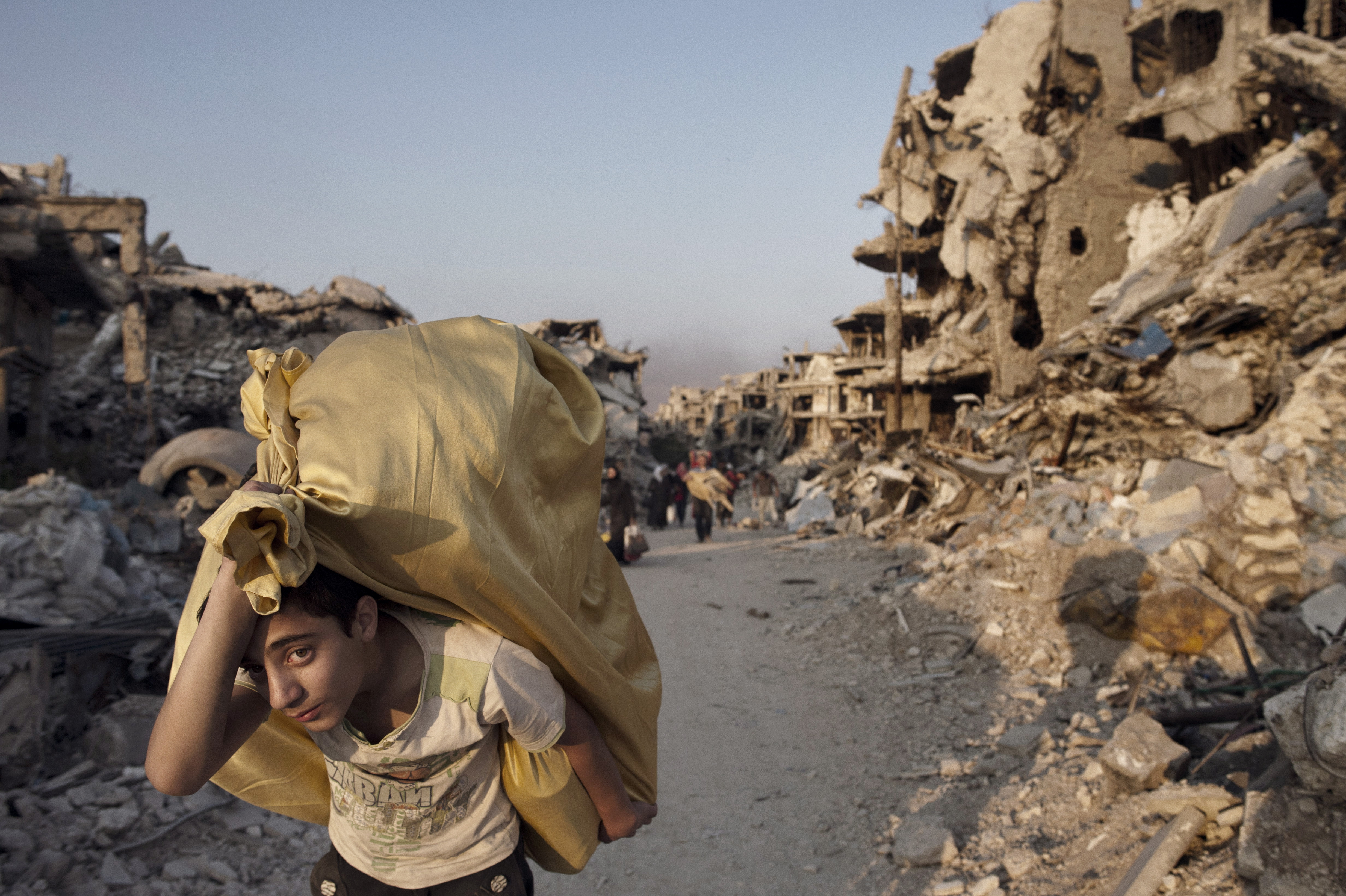 Residents return to devastated Homs to salvage what remains from their homes, May 12, 2014.