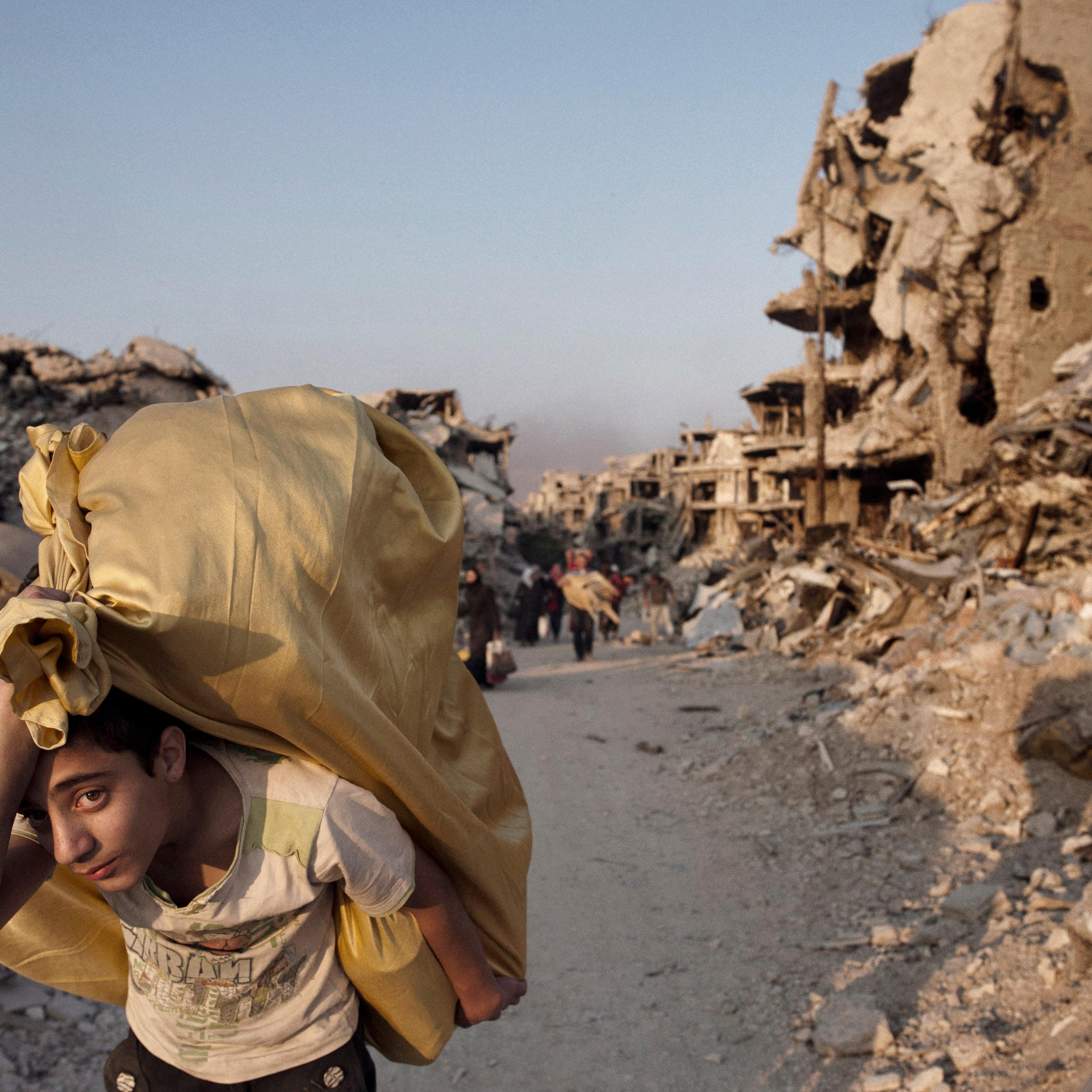 Residents return to devastated Homs to salvage what remains from their homes, May 12, 2014.