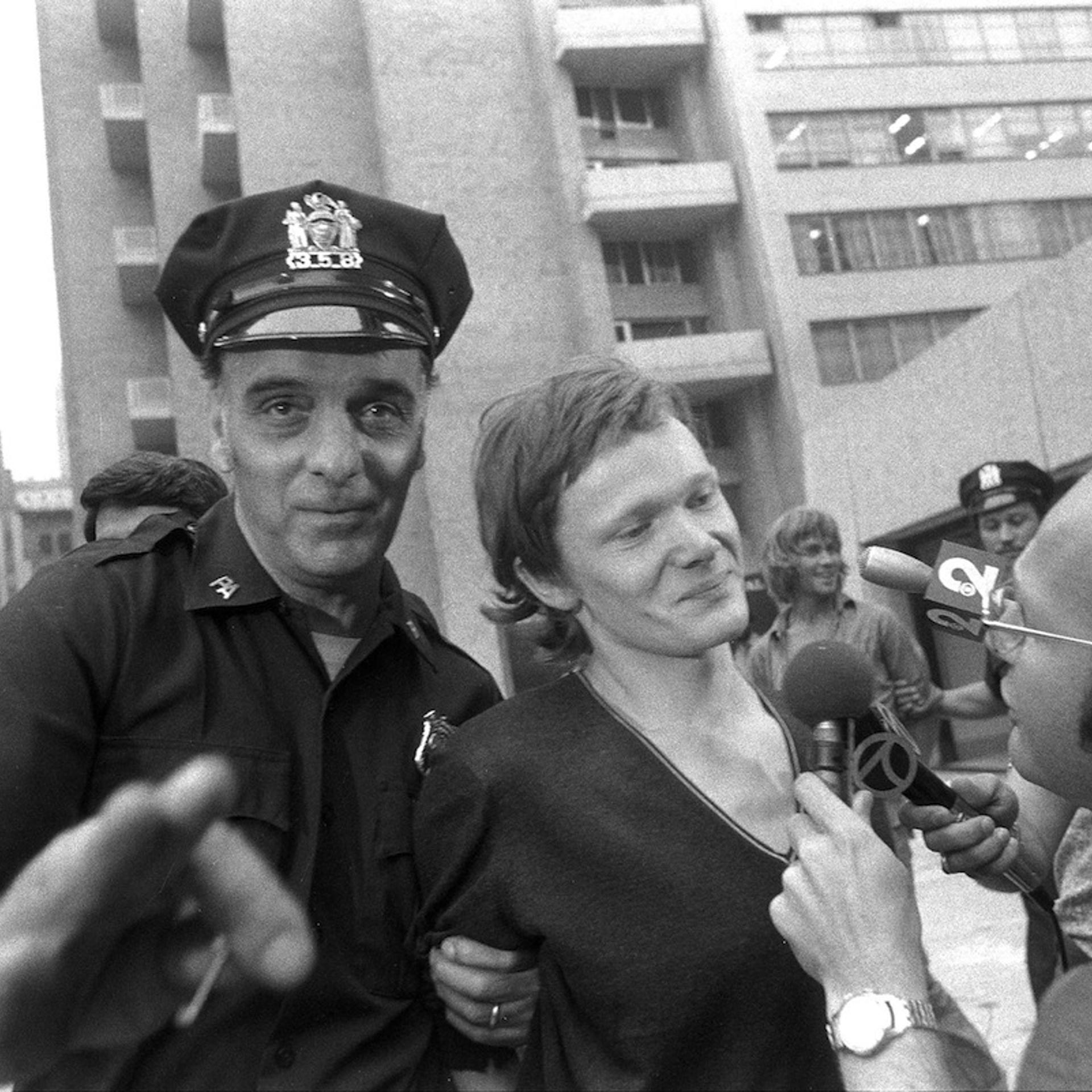 Philippe Petit (center) answers reporter's questions as he i