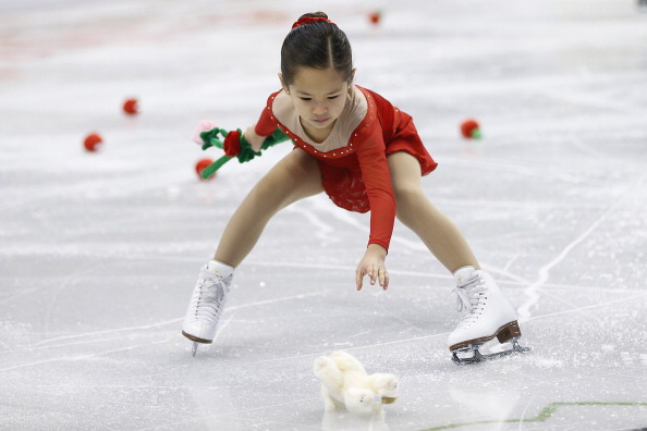 A sweeper picks up stuffed animals and roses at the 2014 Prudential U.S. Figure Skating Championships in Boston, on Jan. 12, 2014.