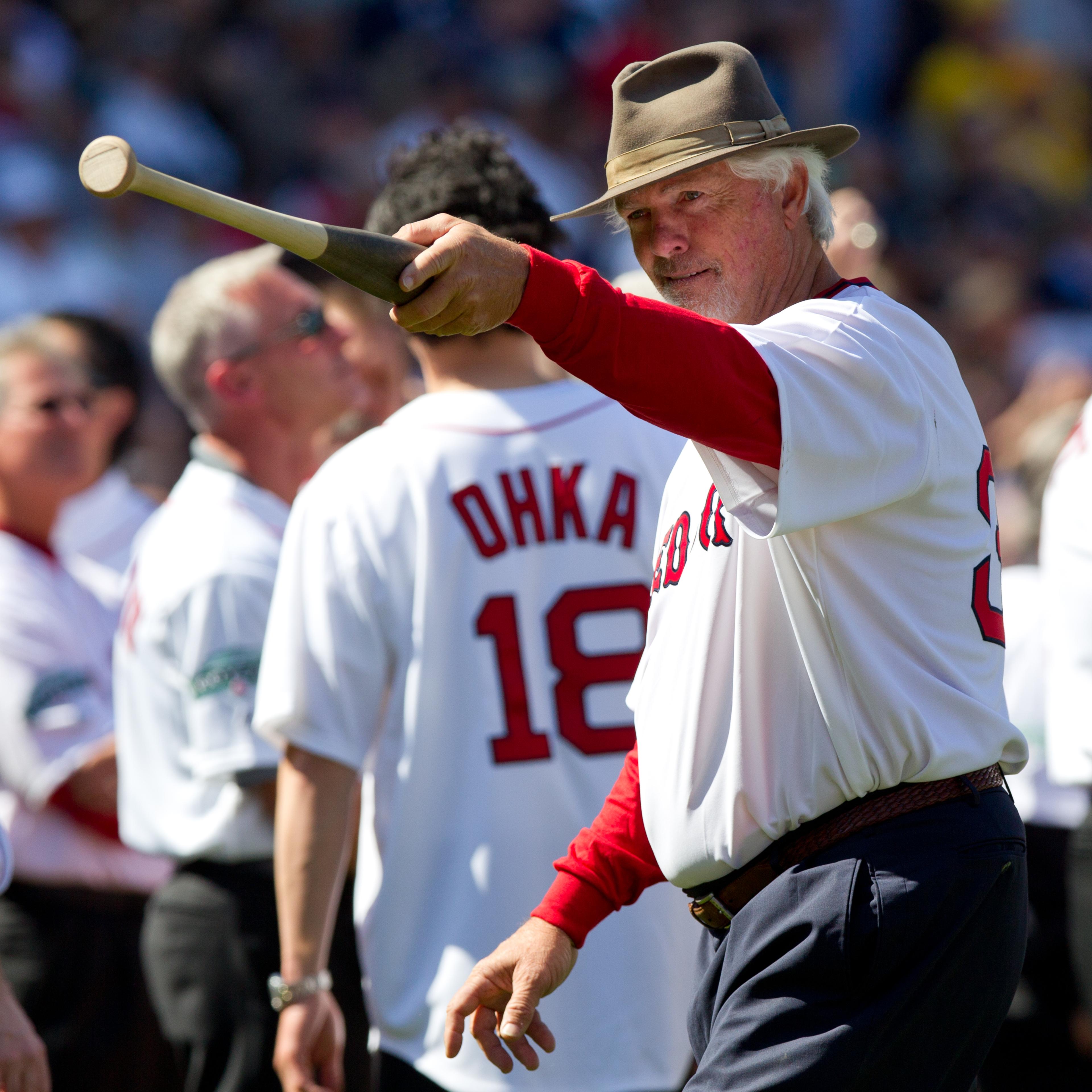 Former Boston Red Sox pitcher Bill "Spaceman" Lee points to the dugout during ceremonies before the game between the Boston Red Sox and the New York Yankees in Boston, April 20, 2012.