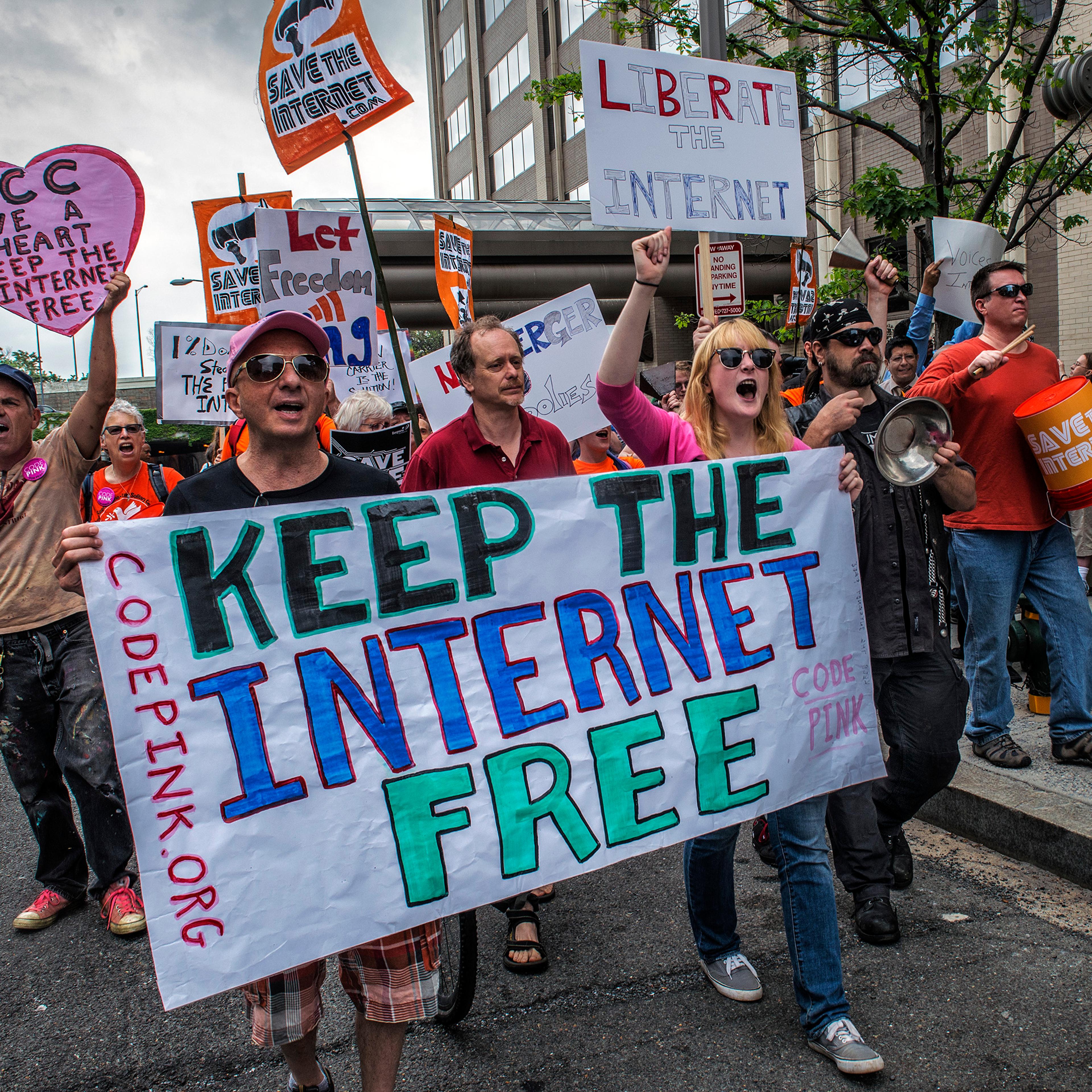Protesters hold a rally before the FCC meeting on net neutrality proposal in Washington, DC.