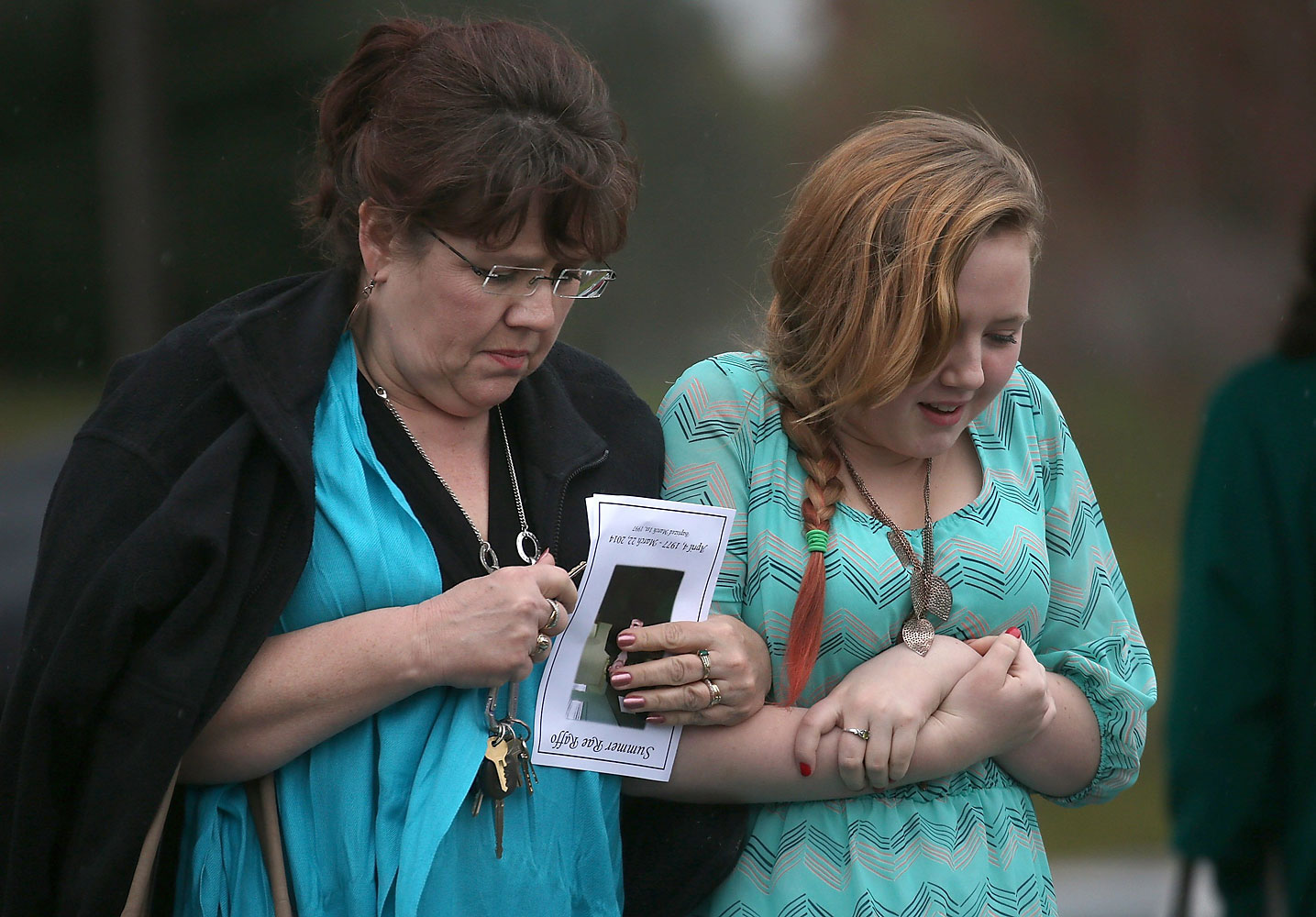 People leave a funeral service for thirty six year-old Summer Raffo, who was killed in the deadly Oso, Washington mudslide, at the Gleneagle Golf Course on April 5, 2014 in Arlington, Wash.