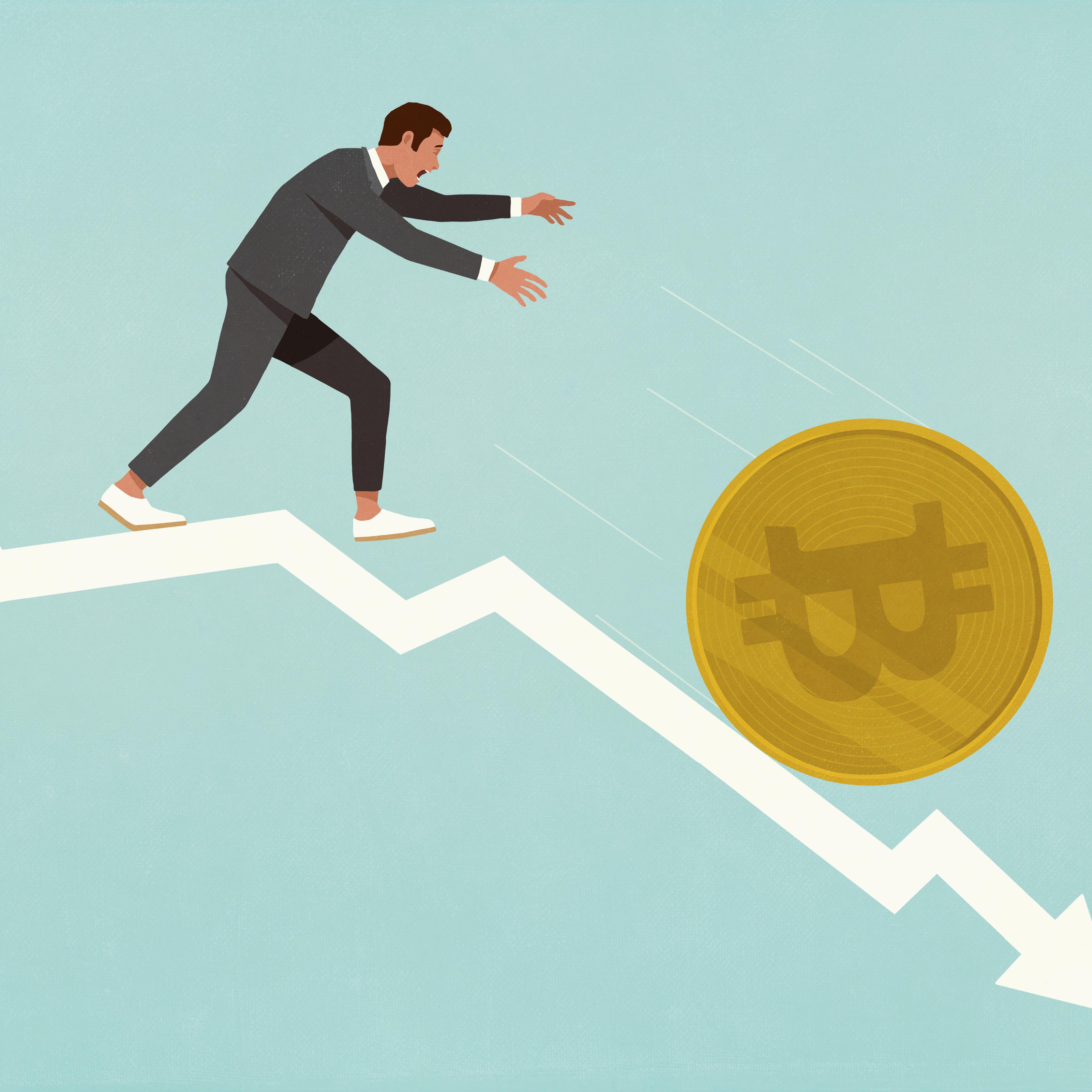 Businessman chasing Bitcoin falling down descending arrow