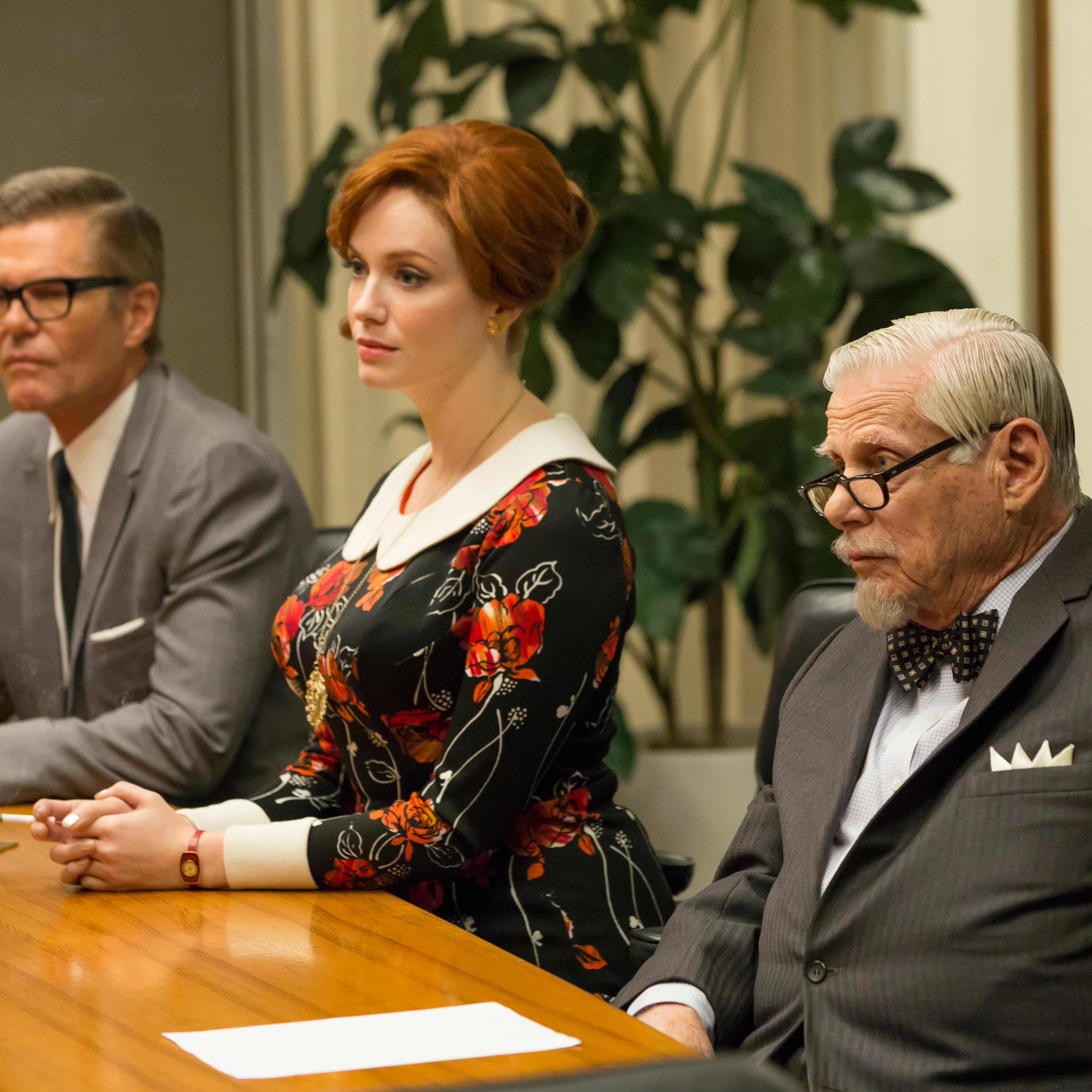 Jim Cutler, Joan Harris, and Bert Cooper at a meeting.