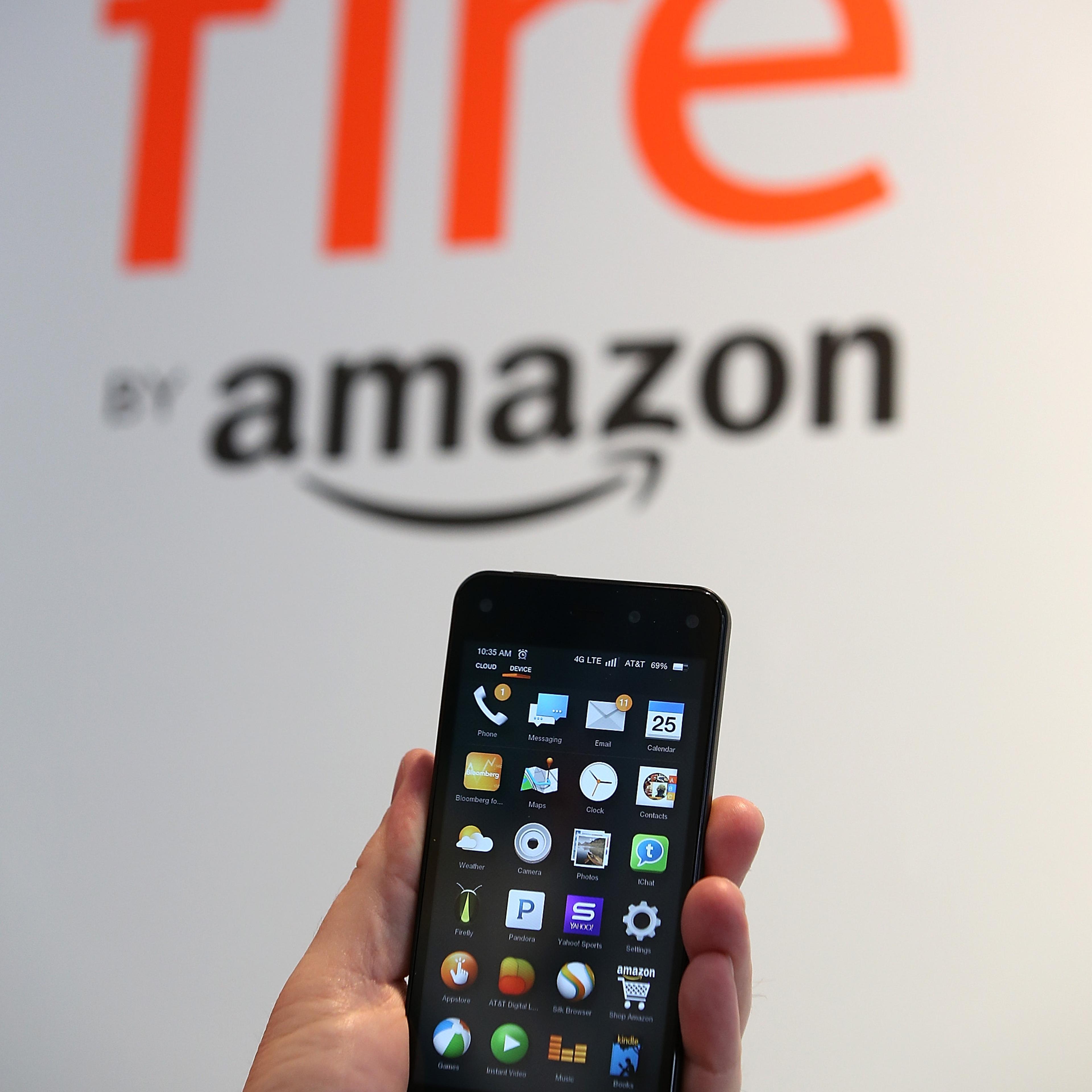 AN AT&T worker holds the new Amazon Fire phone at an AT&T store on July 25, 2014 in San Francisco.