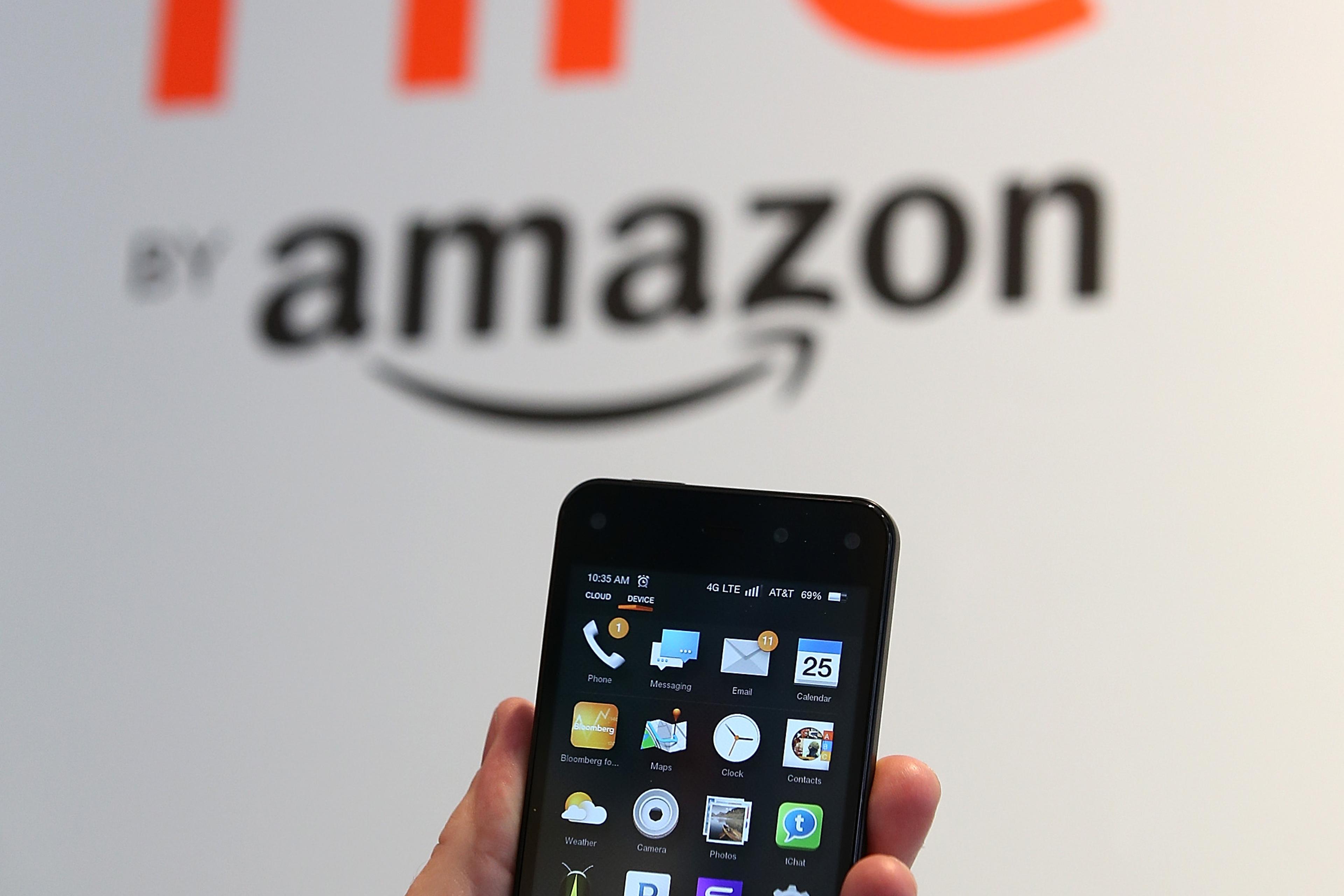 AN AT&T worker holds the new Amazon Fire phone at an AT&T store on July 25, 2014 in San Francisco.