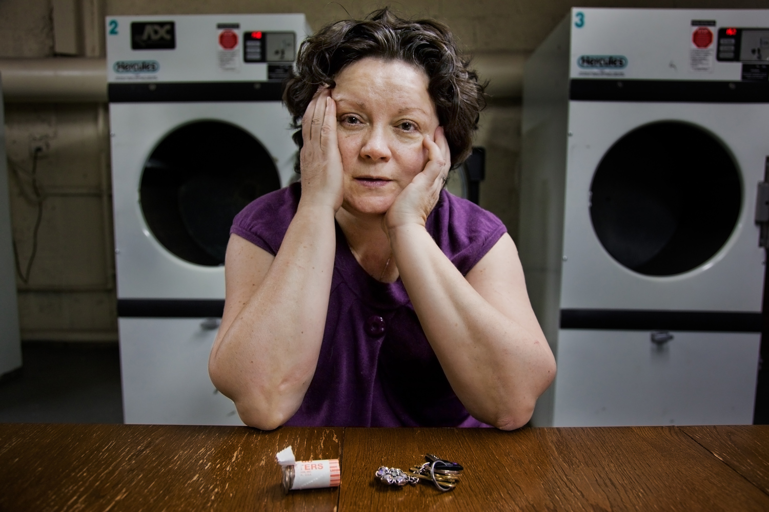 The photographer's mother-in-law Anna Rainska waits for her laundry in the basement of her building in Rego Park, Queens. 