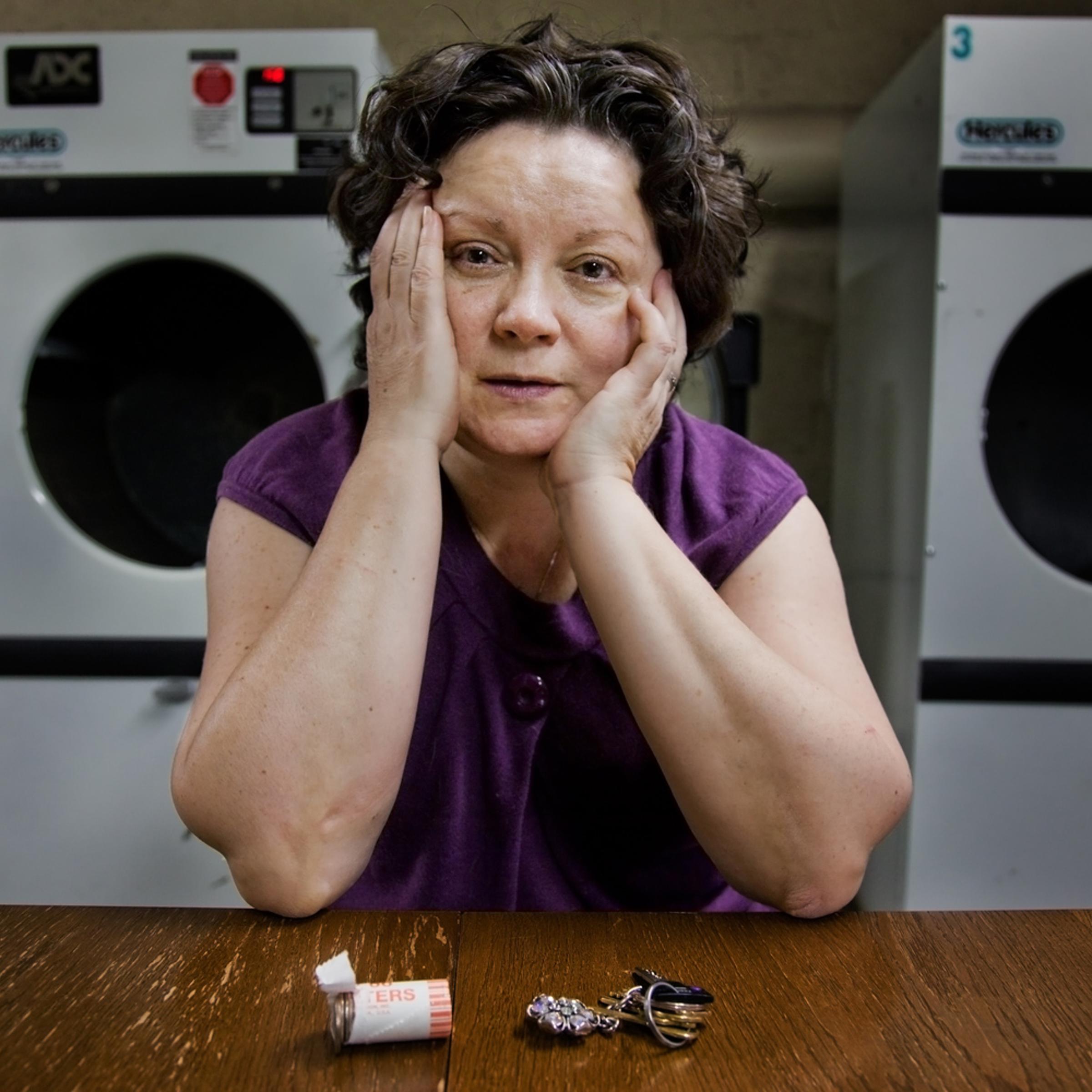 The photographer's mother-in-law Anna Rainska waits for her laundry in the basement of her building in Rego Park, Queens.