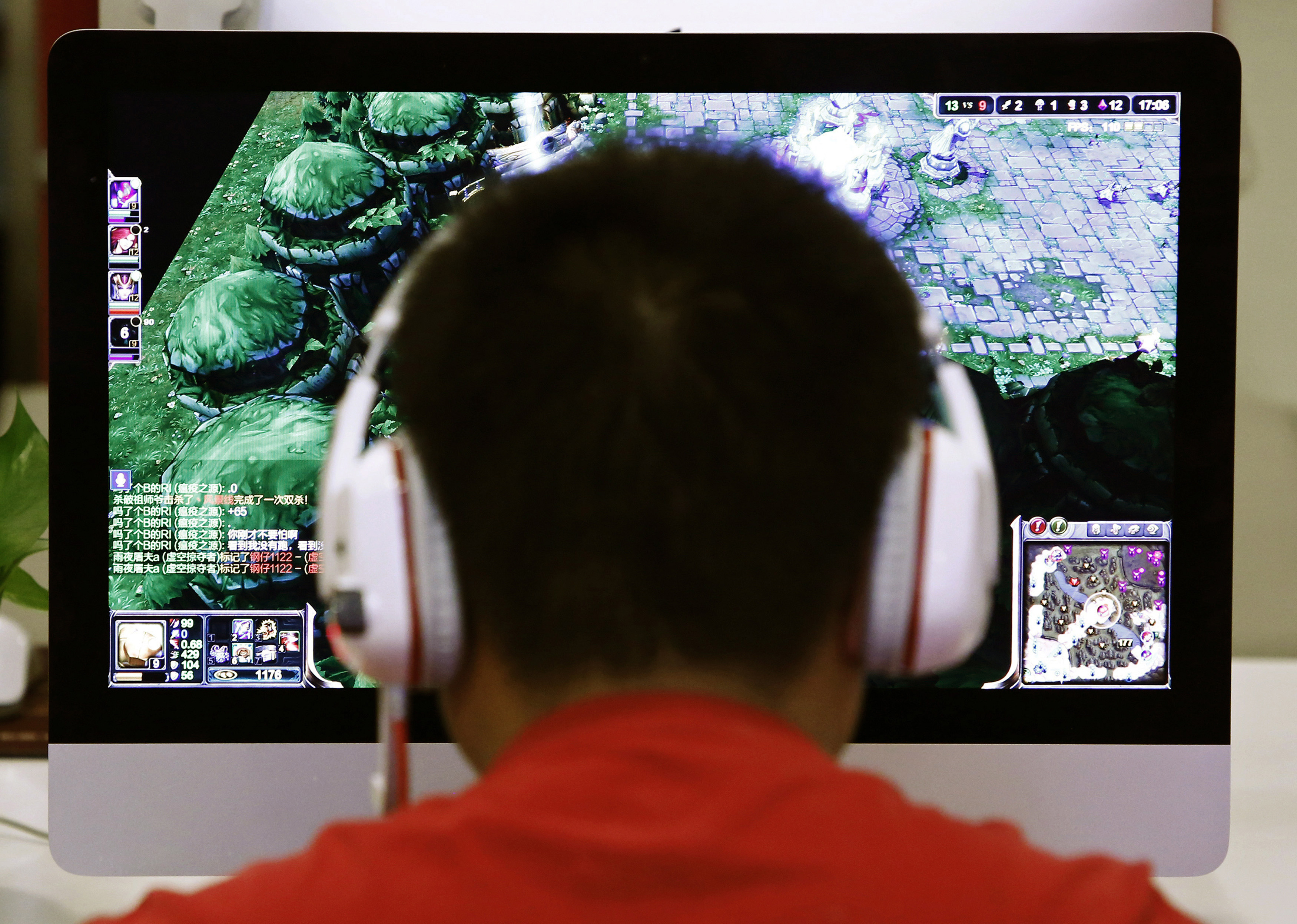 A man plays a computer game at an internet cafe in Beijing