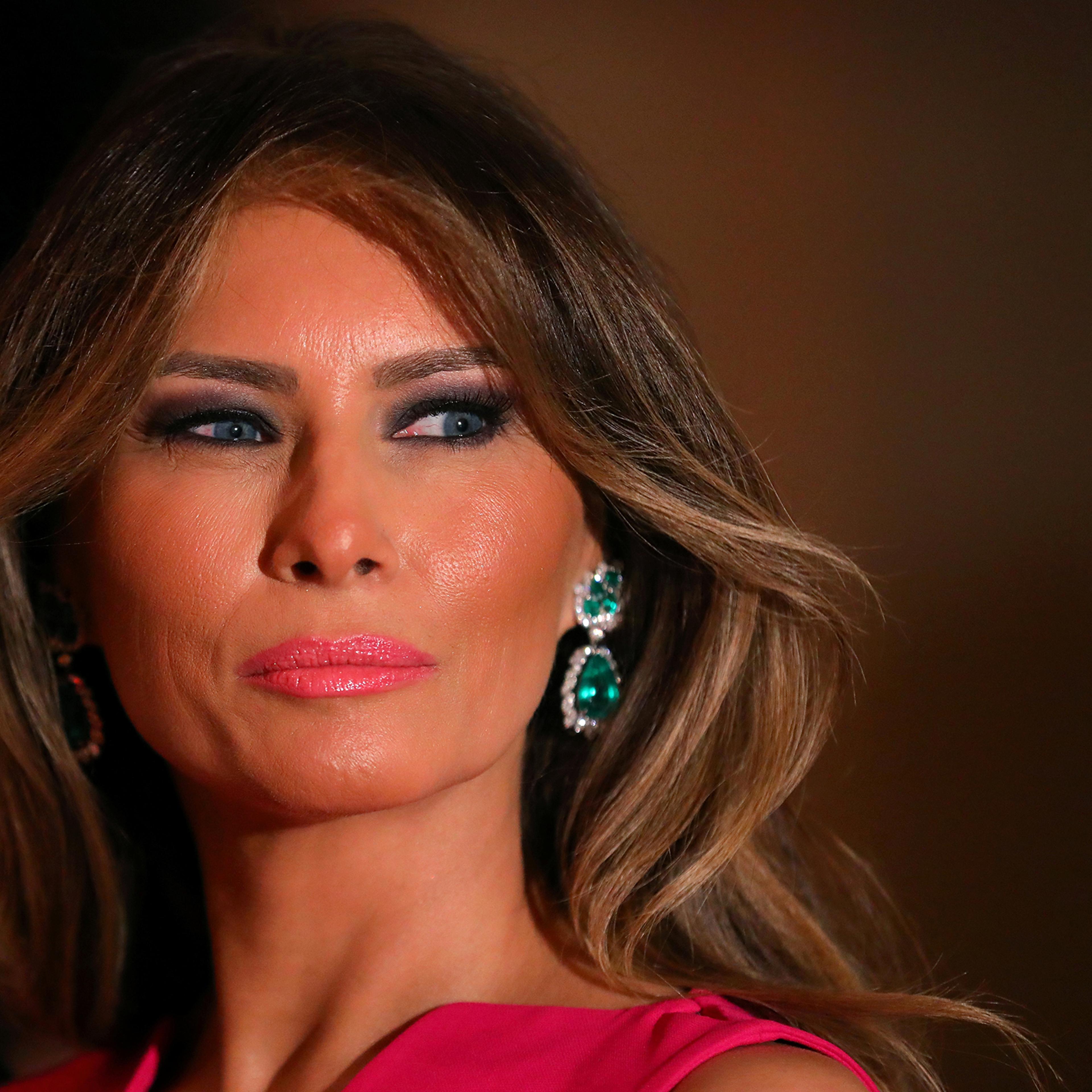 First Lady Melania Trump wearing bright pink Dior gown with emerald and diamond earrings, attends the 60th Annual Red Cross Gala at Mar-a-Lago club in Palm Beach, Fla, Feb. 4, 2017.