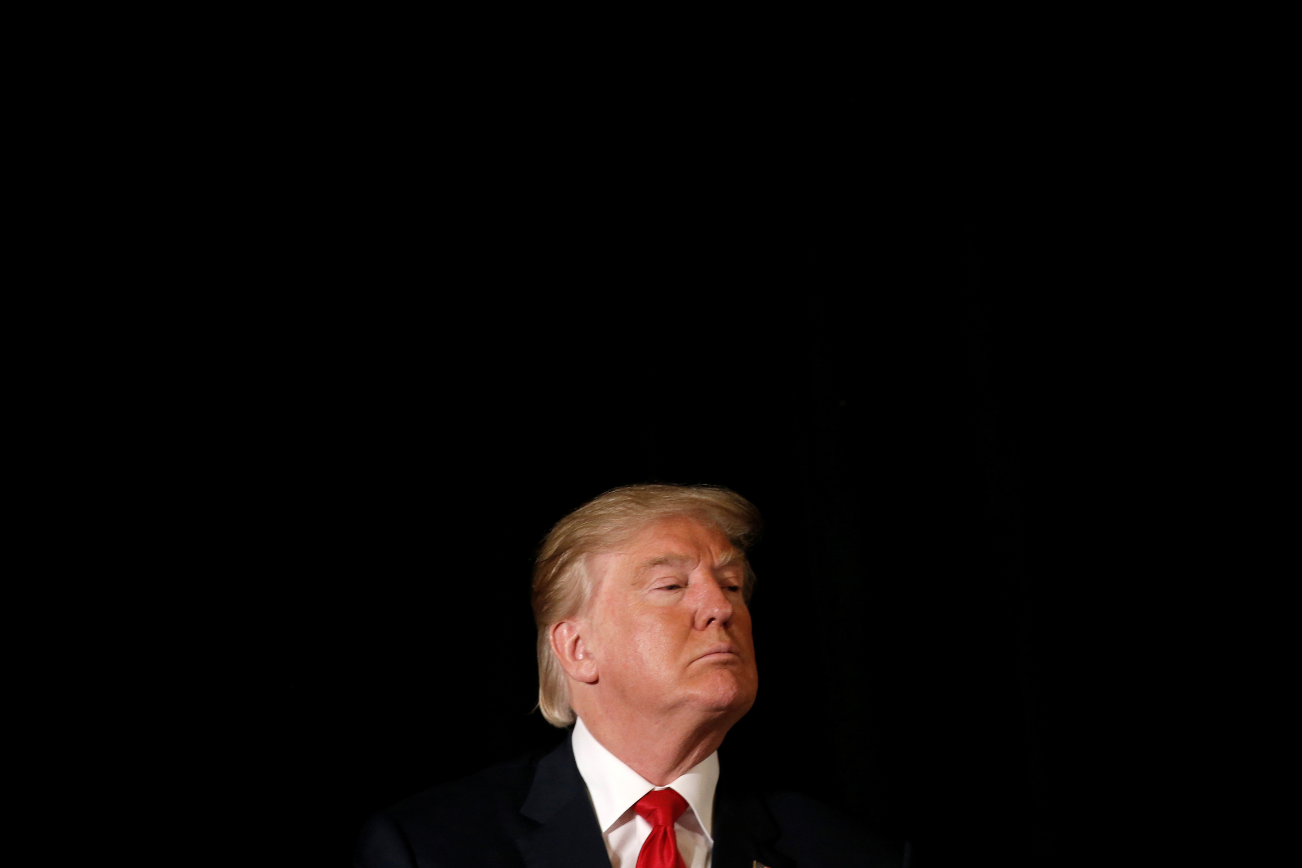 Republican presidential nominee Donald Trump listens to a question as he appears at the "Retired American Warriors" conference during a campaign stop in Herndon, Virginia, U.S., October 3, 2016. REUTERS/Mike Segar - RTSQKJJ